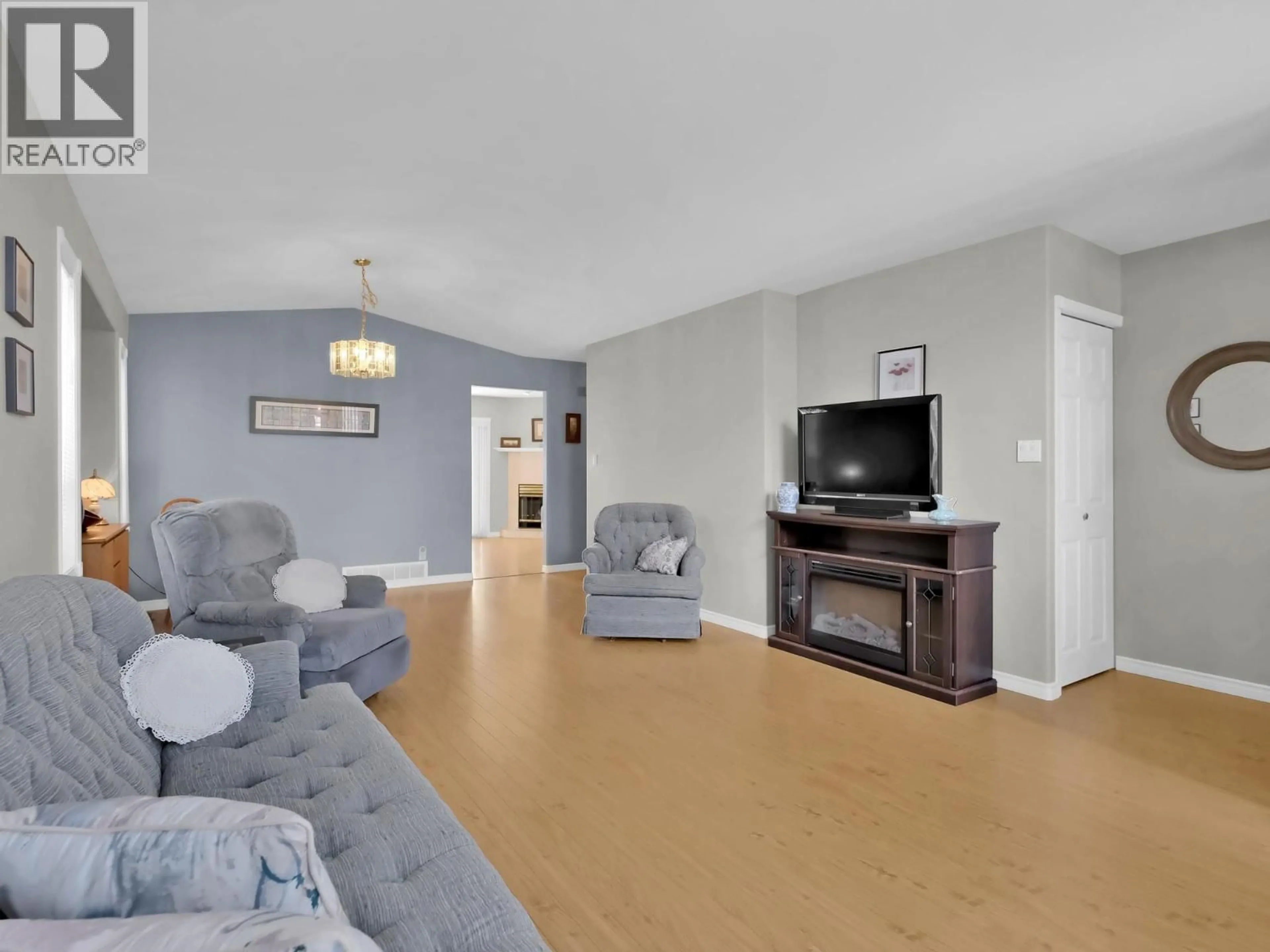 Living room with furniture, wood/laminate floor for 125 - 1634 CARMI AVENUE, Penticton British Columbia V2A8K5