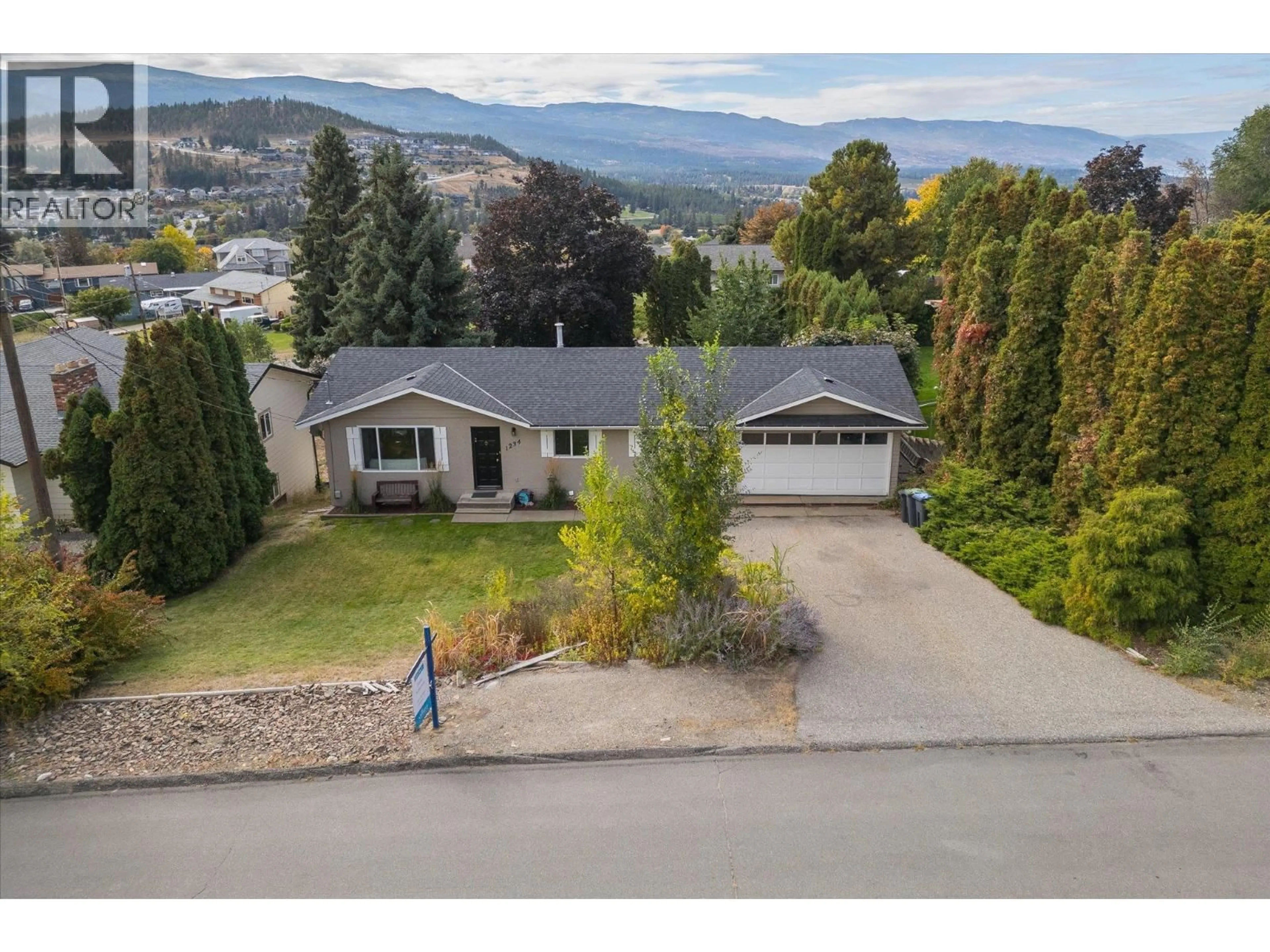 A pic from outside/outdoor area/front of a property/back of a property/a pic from drone, mountain view for 1234 OSWELL DRIVE, Kelowna British Columbia V1P1L6
