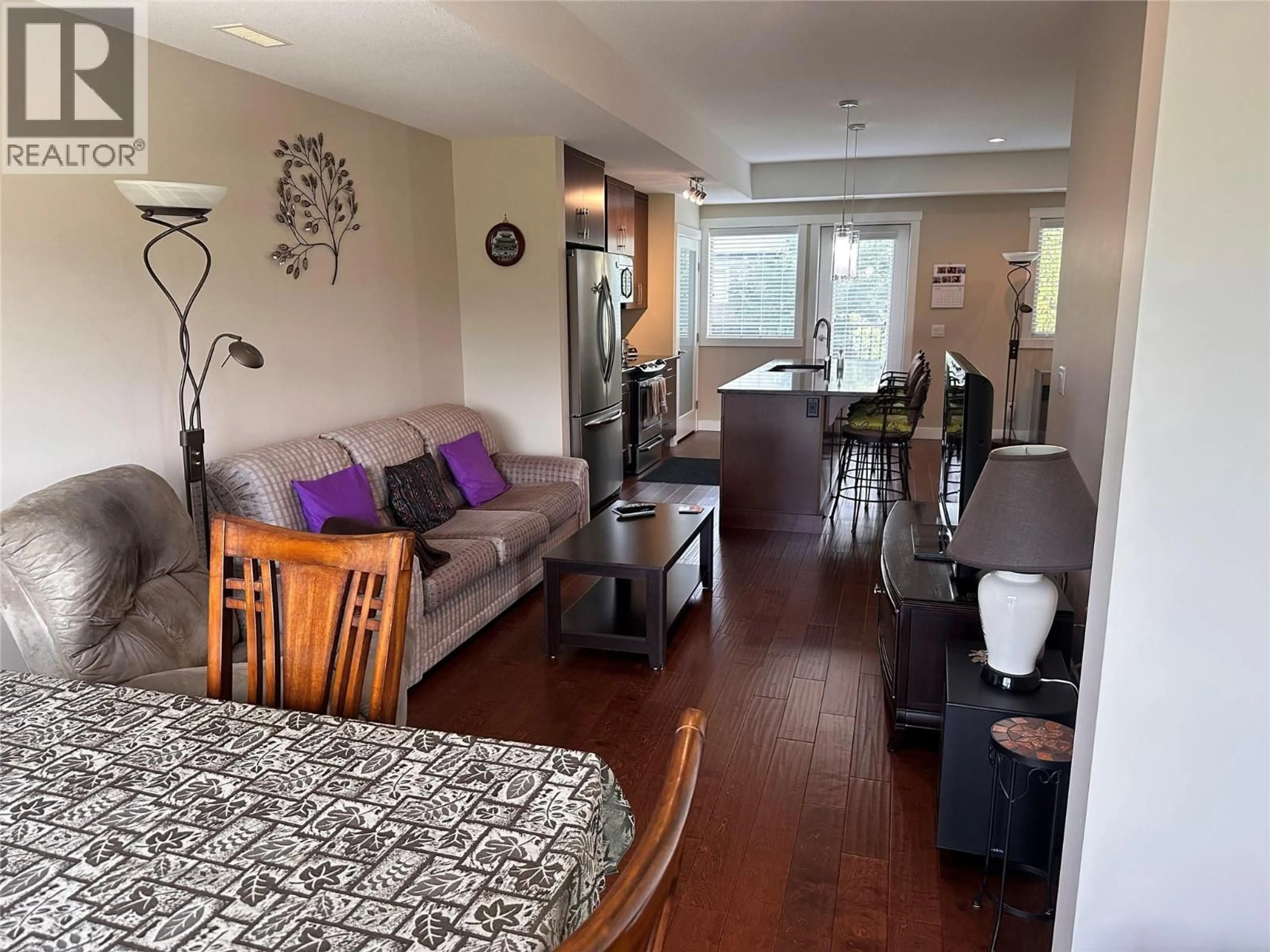 Living room with furniture, wood/laminate floor for 37 - 3626 MISSION SPRINGS DRIVE, Kelowna British Columbia V1W5L1
