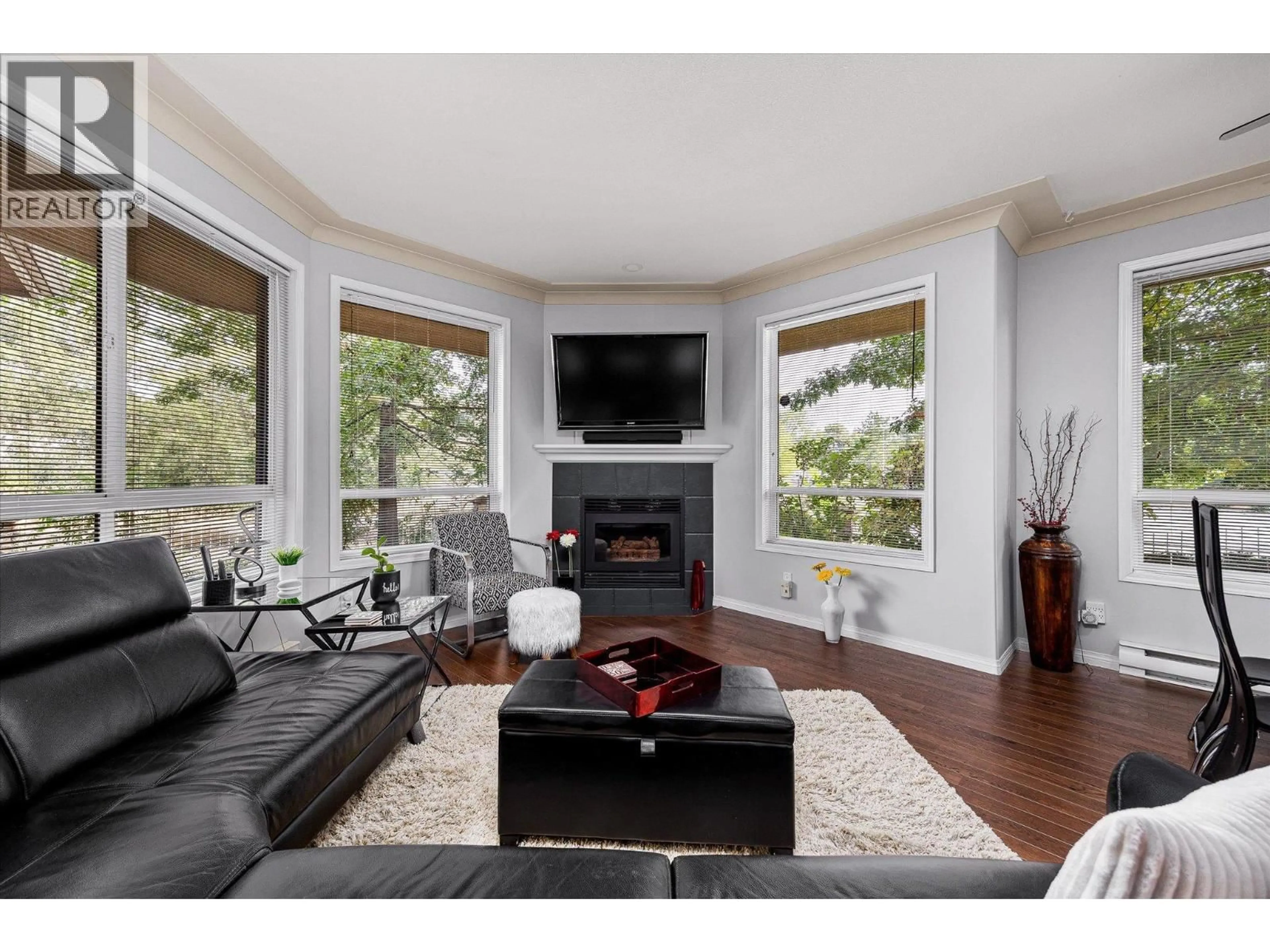 Living room with furniture, wood/laminate floor for 115 - 1964 ENTERPRISE WAY, Kelowna British Columbia V1Y9S7