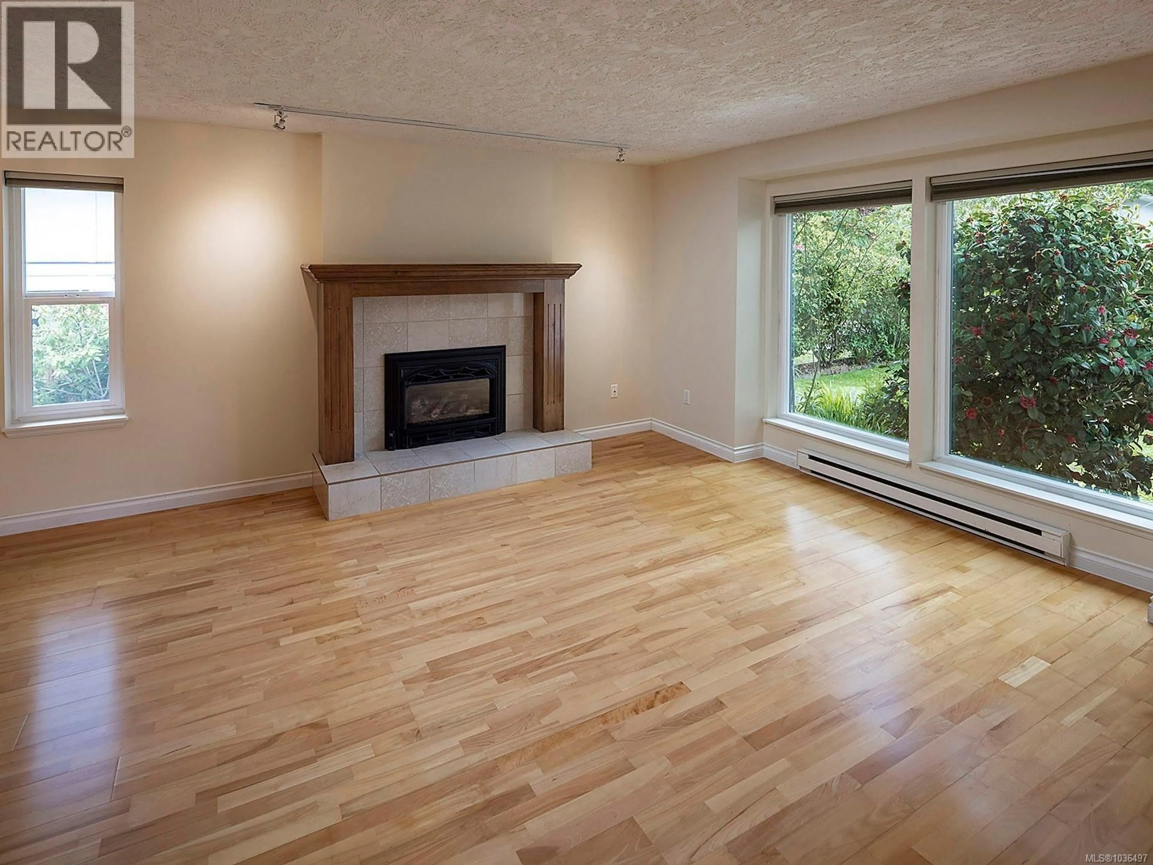Living room with furniture, wood/laminate floor for 4023 MALTON AVENUE, Saanich British Columbia V8X4W3