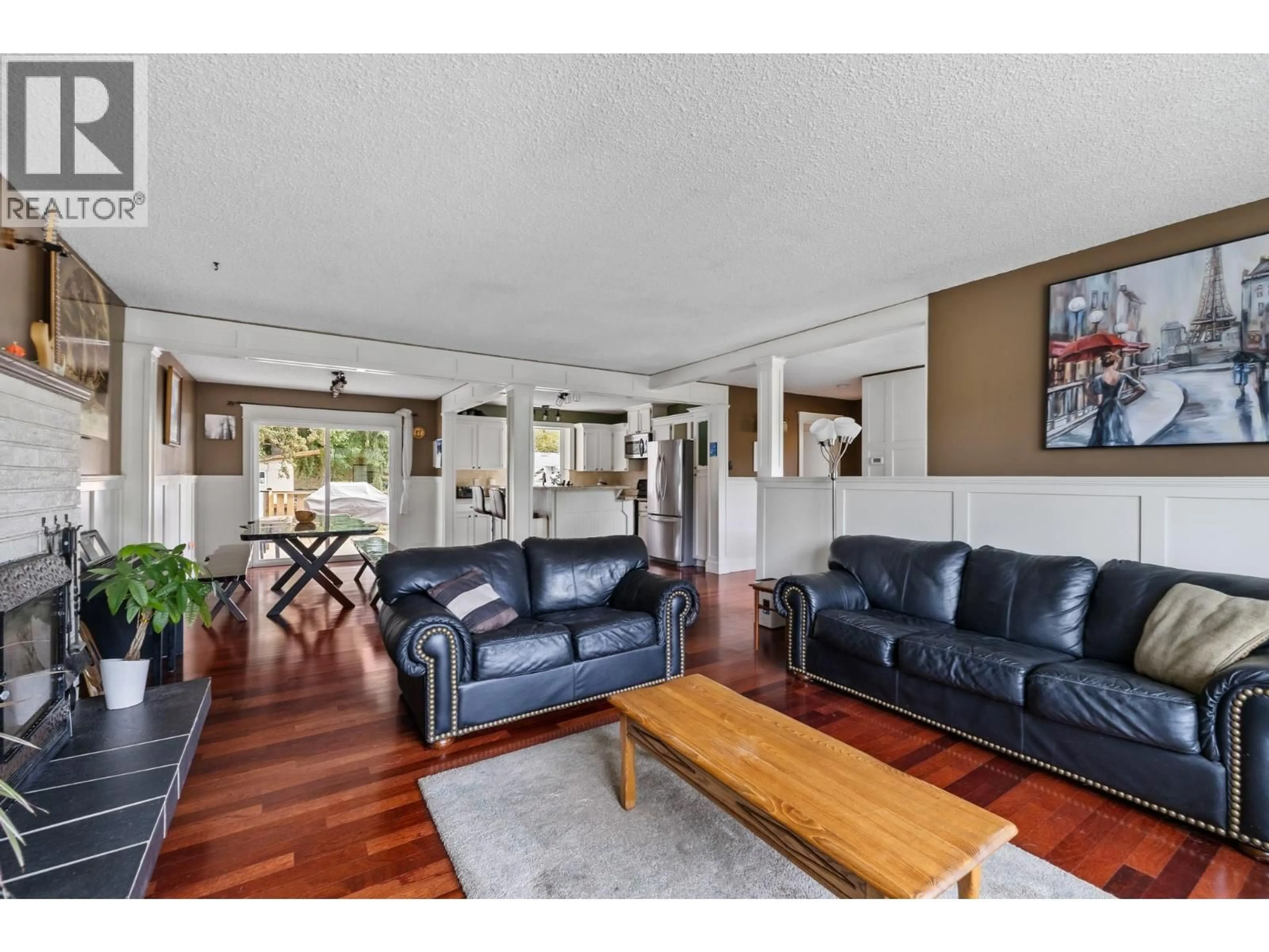 Living room with furniture, wood/laminate floor for 1342 MCBRIDE ROAD, Kelowna British Columbia V1Y4A6