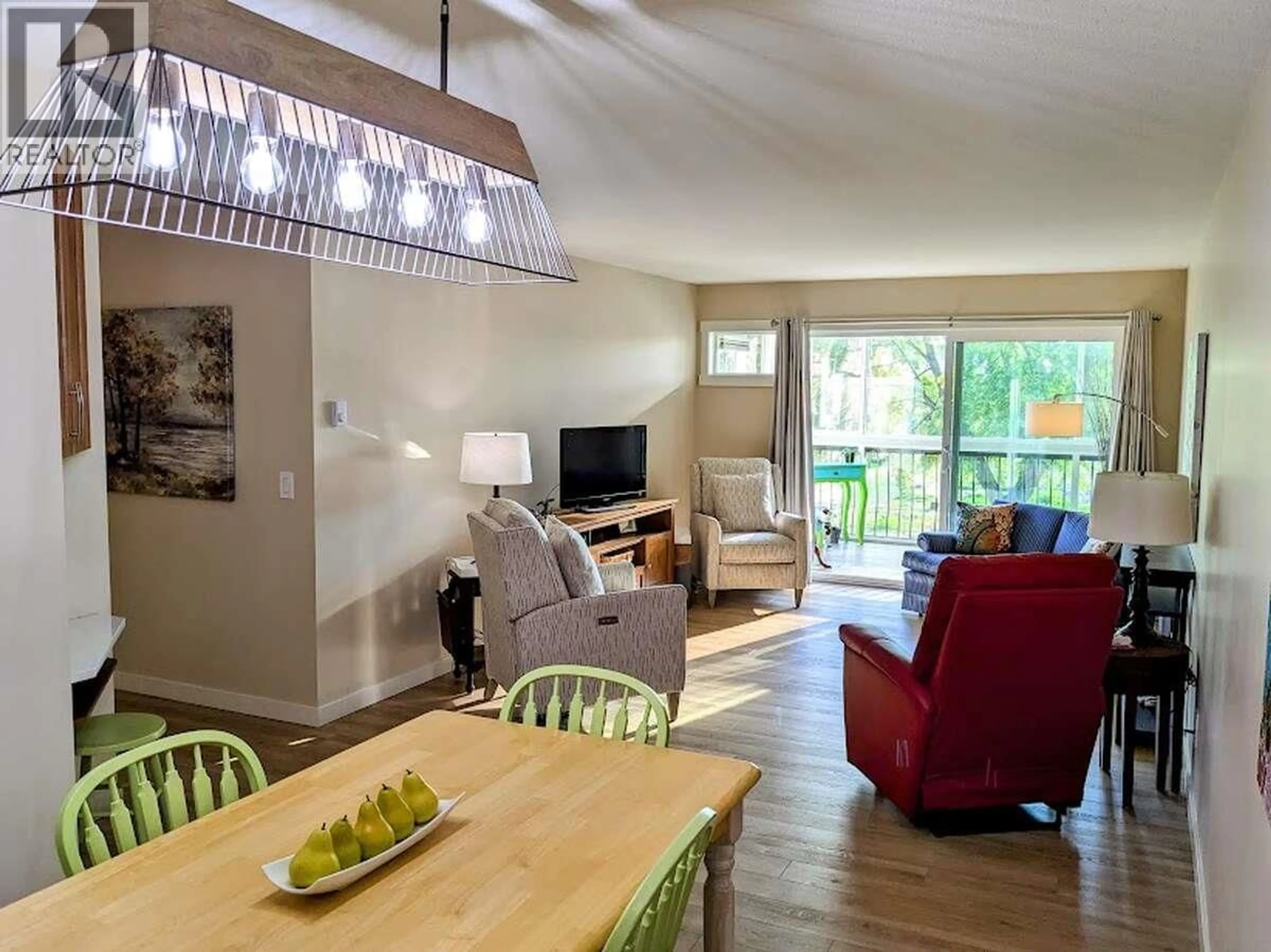 Living room with furniture, wood/laminate floor for 302 - 1450 BERTRAM STREET, Kelowna British Columbia V1Y8R9