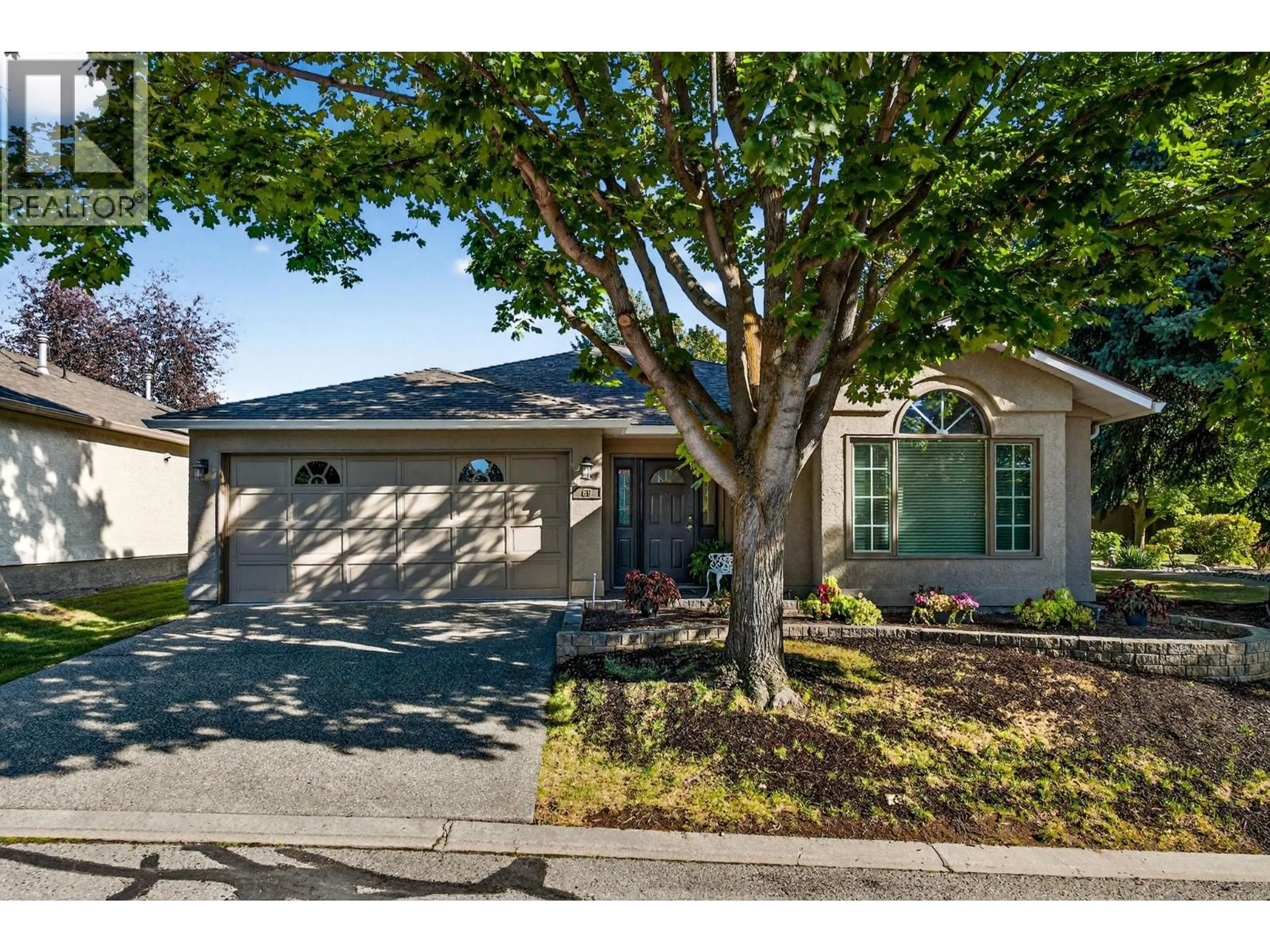 Home with vinyl exterior material, street for 69 - 615 GLENMEADOWS ROAD, Kelowna British Columbia V1V1N9