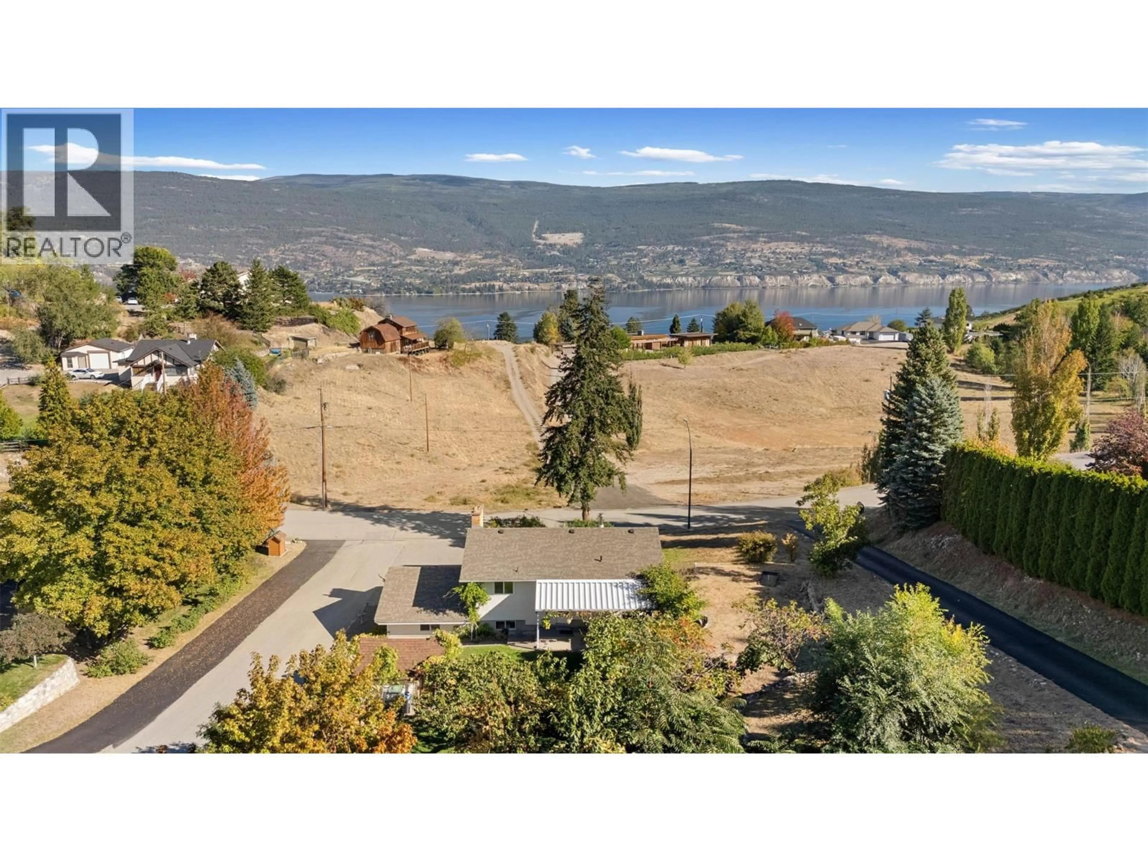 A pic from outside/outdoor area/front of a property/back of a property/a pic from drone, water/lake/river/ocean view for 10212 HAPPY VALLEY ROAD, Summerland British Columbia V0H1Z7