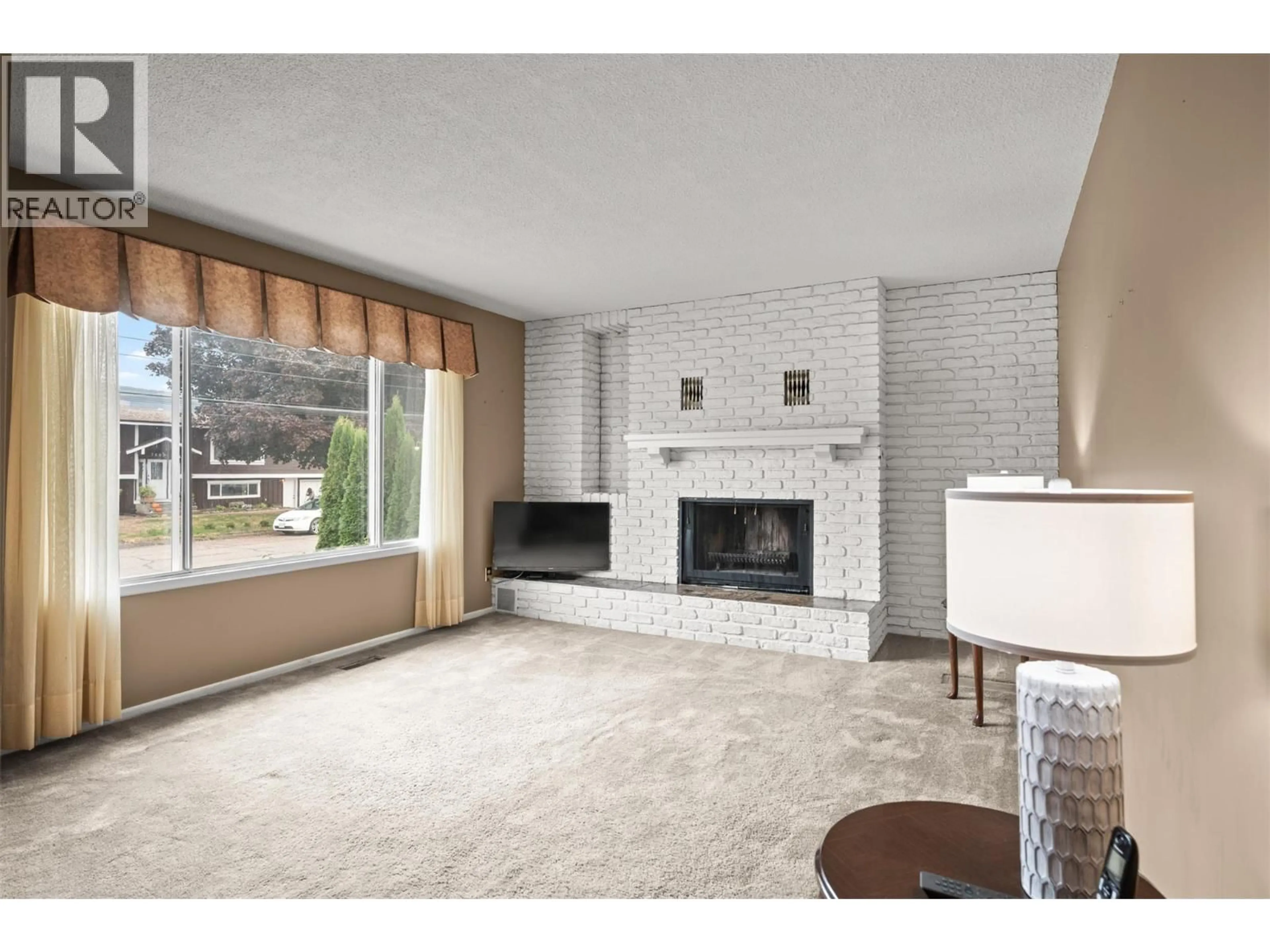 Living room with furniture, ceramic/tile floor for 7612 BIRCH LANE, Coldstream British Columbia V1B1N9