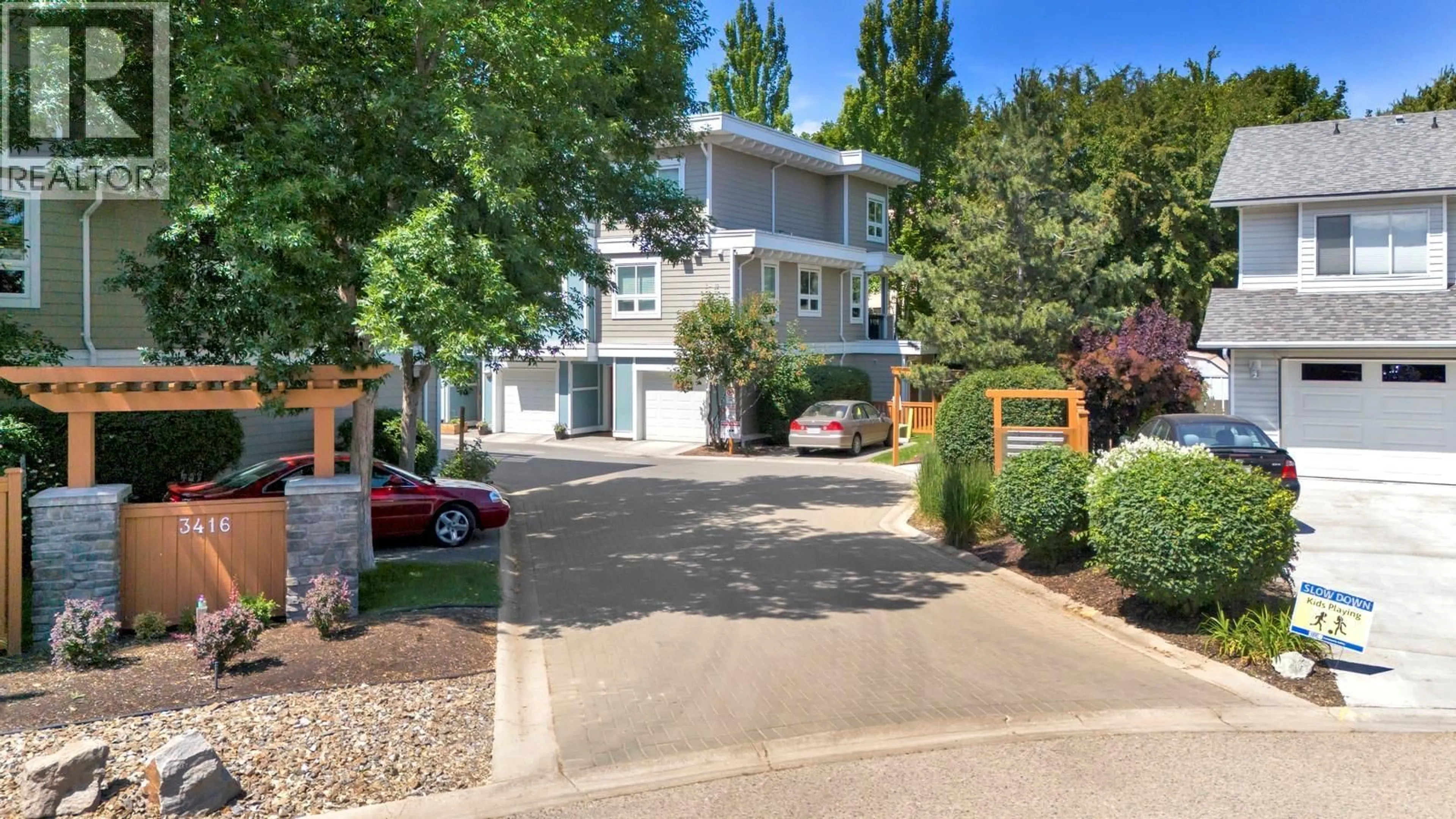 A pic from outside/outdoor area/front of a property/back of a property/a pic from drone, street for 8 - 3416 SCOTT ROAD, Kelowna British Columbia V1W3H3