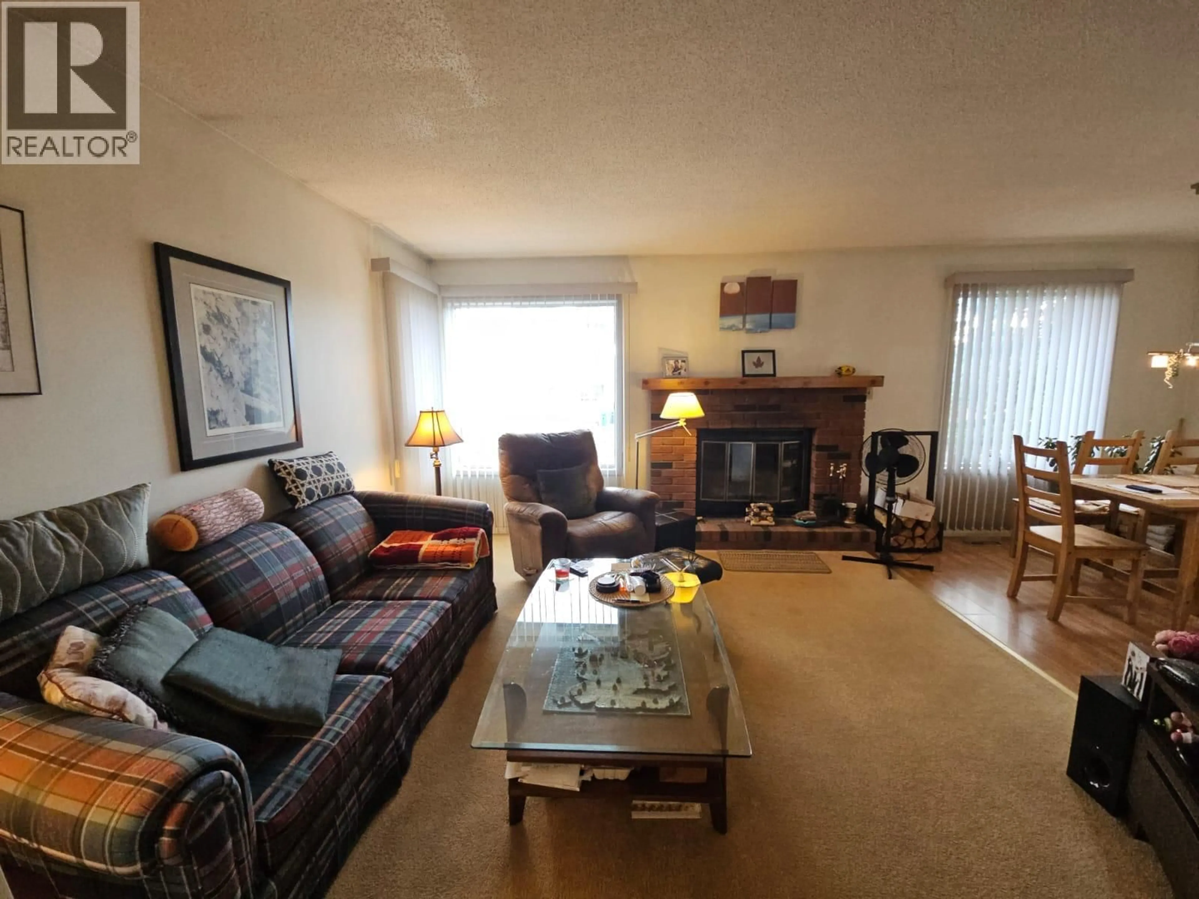 Living room with furniture, wood/laminate floor for 112 PEACE RIVER CRESCENT, Tumbler Ridge British Columbia V0C2W0