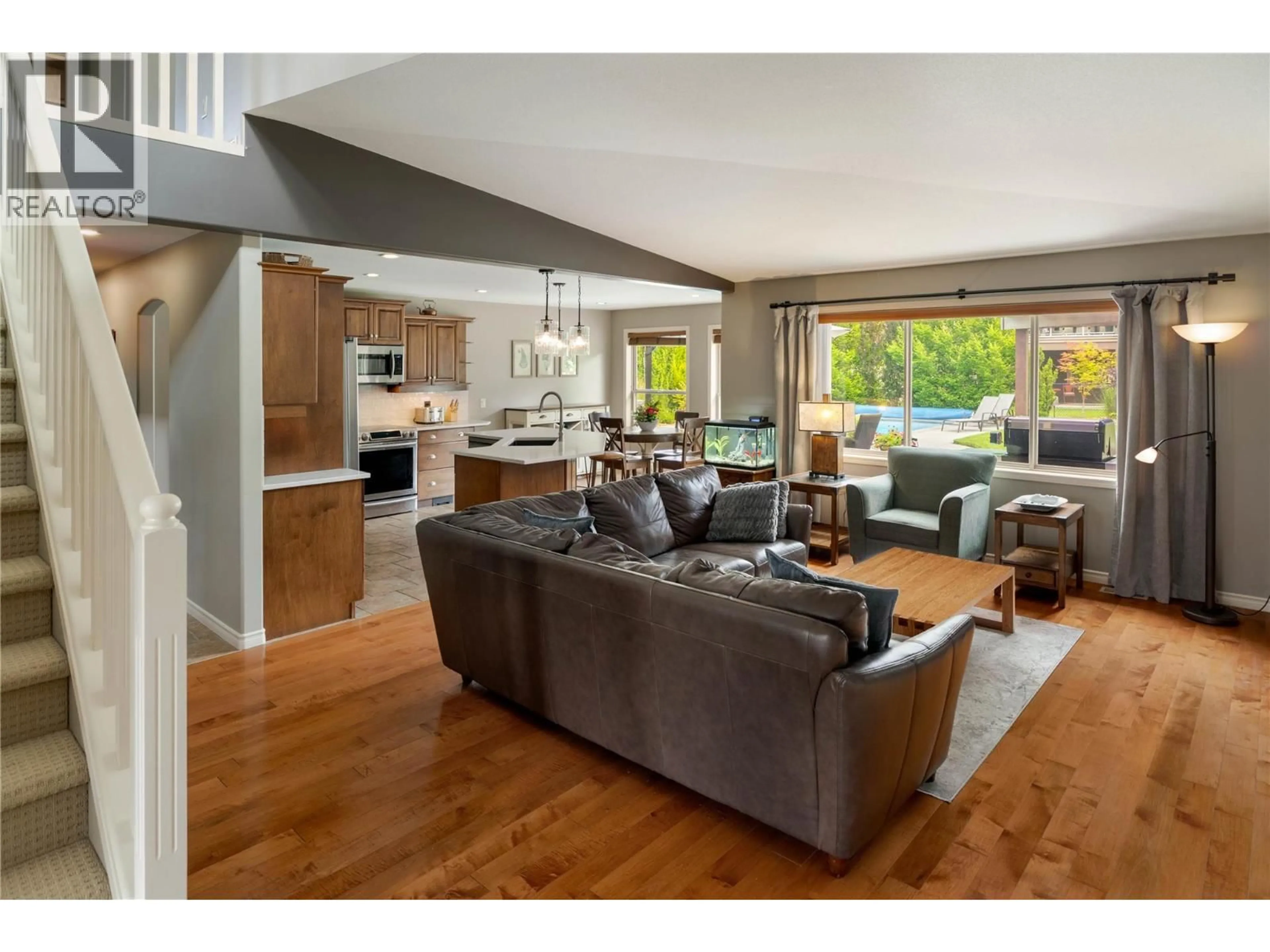 Living room with furniture, wood/laminate floor for 2464 SELKIRK DRIVE, Kelowna British Columbia V1V2R7