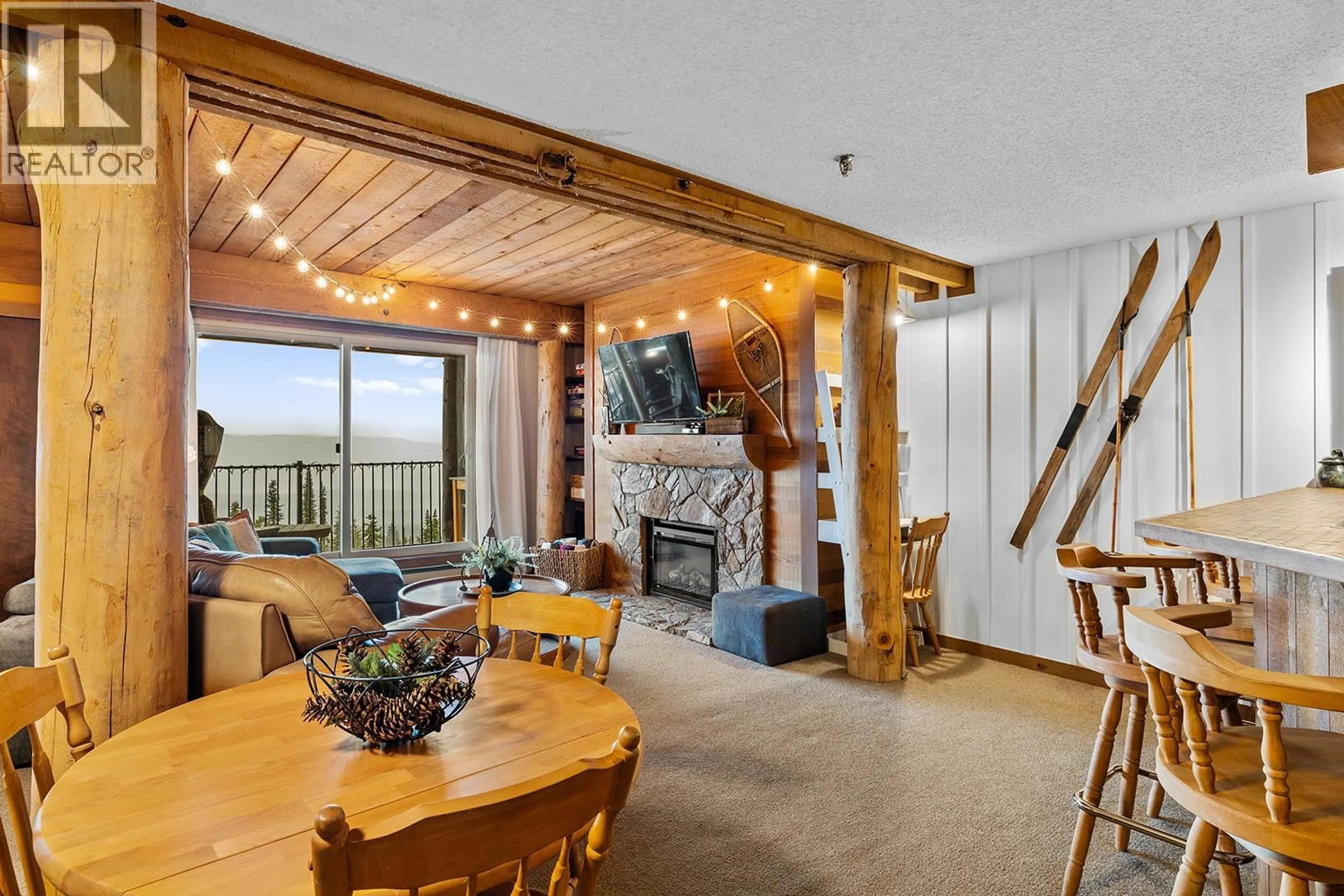 Living room with furniture, wood/laminate floor for 804 - 7470 PORCUPINE ROAD, Big White British Columbia V1P1P3