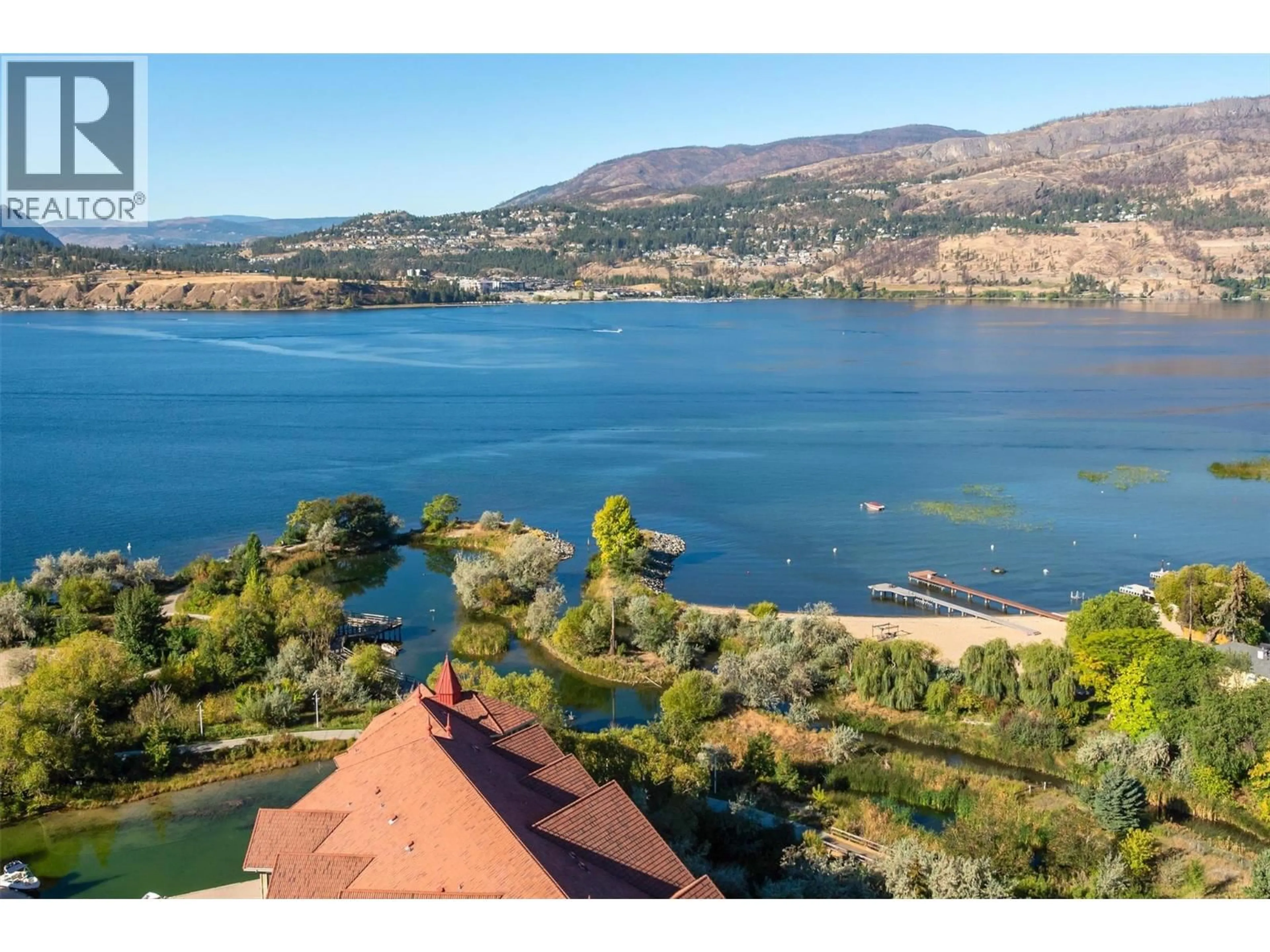 A pic from outside/outdoor area/front of a property/back of a property/a pic from drone, water/lake/river/ocean view for 2408 - 1075 SUNSET DRIVE, Kelowna British Columbia V1Y9Y9