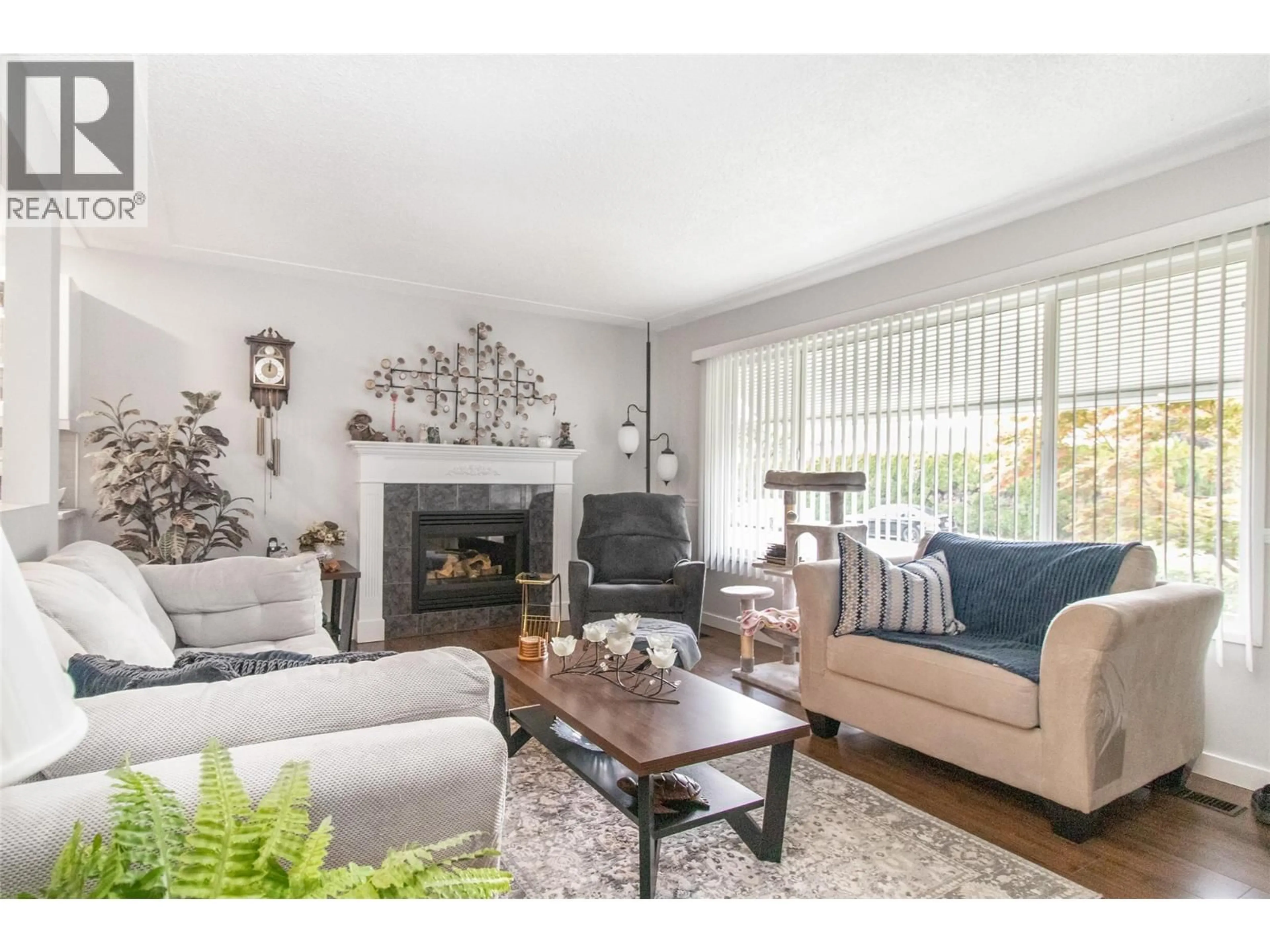 Living room with furniture, wood/laminate floor for 230 PONTO ROAD, Kelowna British Columbia V1X2G1