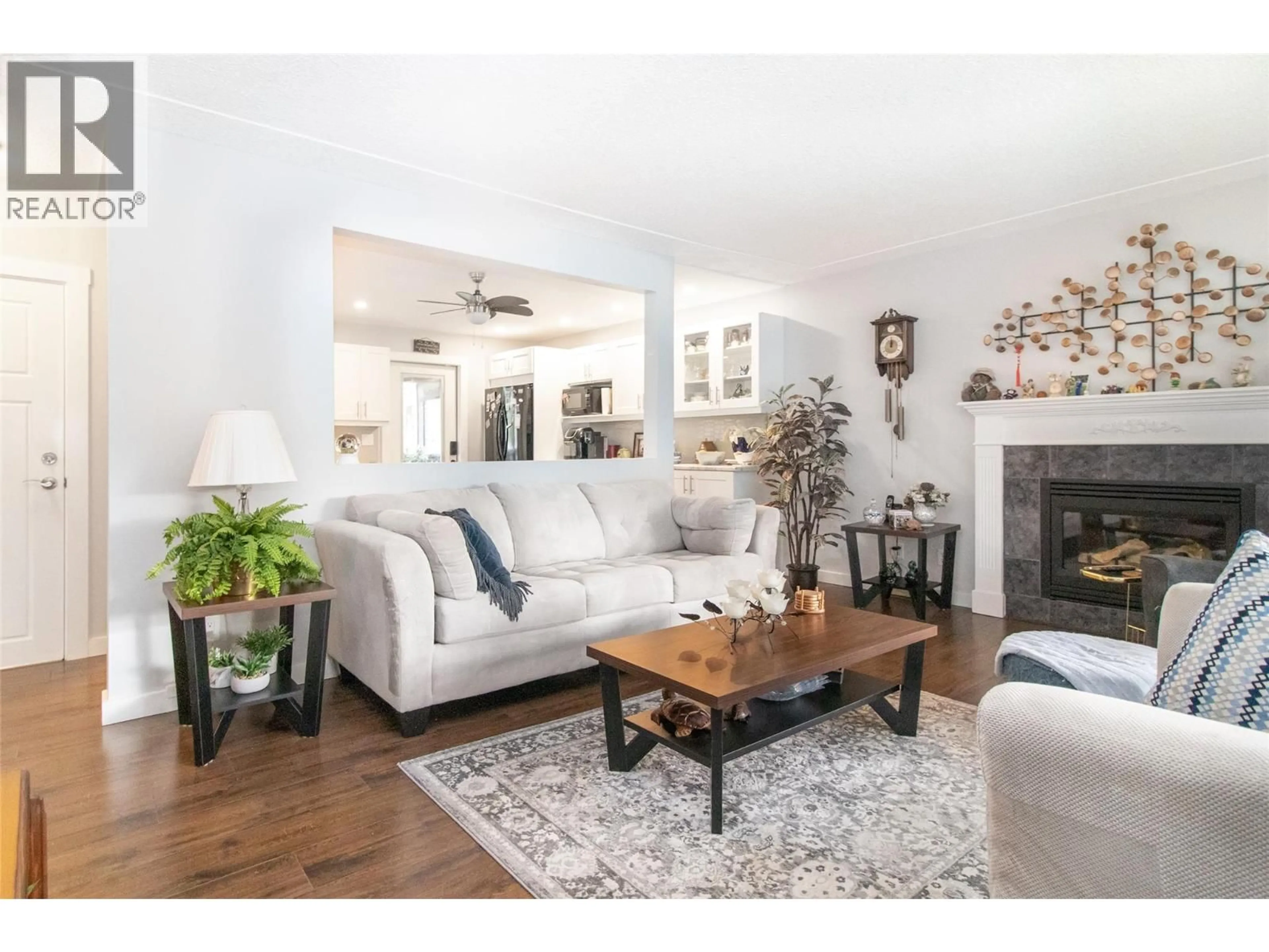 Living room with furniture, wood/laminate floor for 230 PONTO ROAD, Kelowna British Columbia V1X2G1