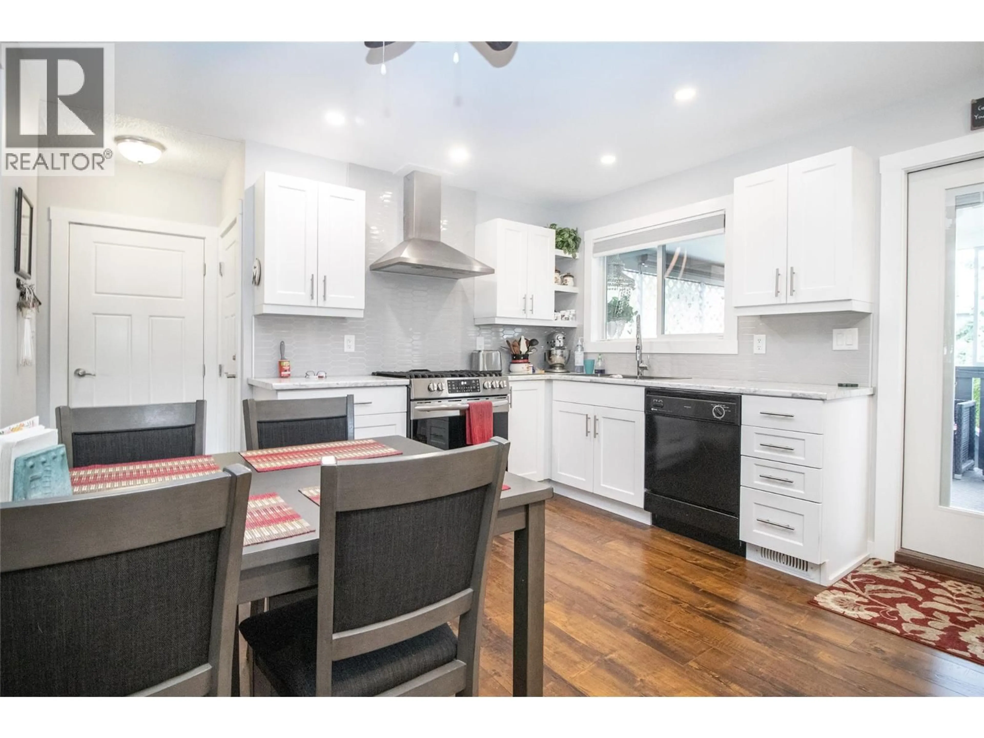 Open concept kitchen, wood/laminate floor for 230 PONTO ROAD, Kelowna British Columbia V1X2G1