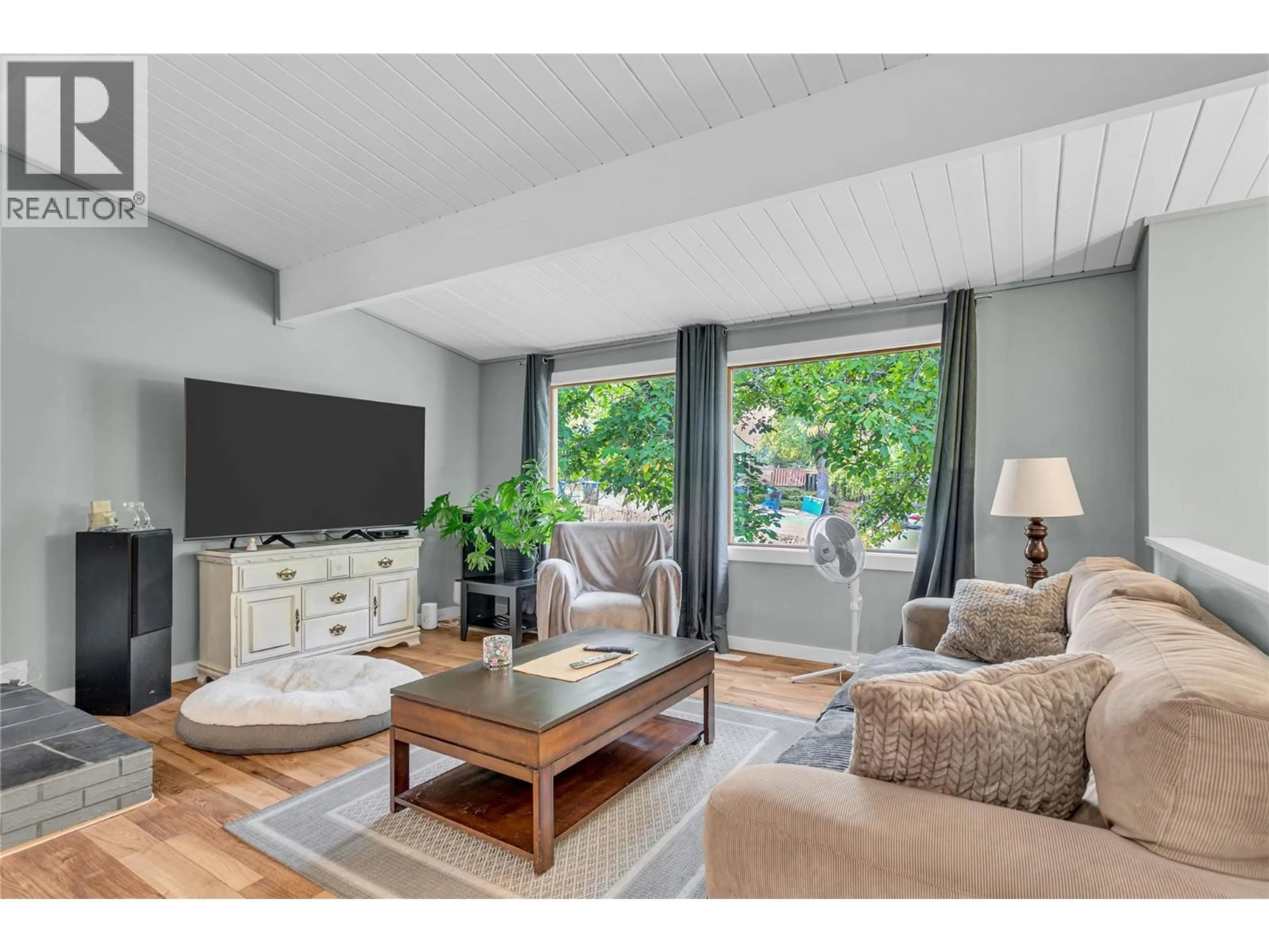 Living room with furniture, wood/laminate floor for 1415 HIGHLAND DRIVE SOUTH, Kelowna British Columbia V1Y3W3