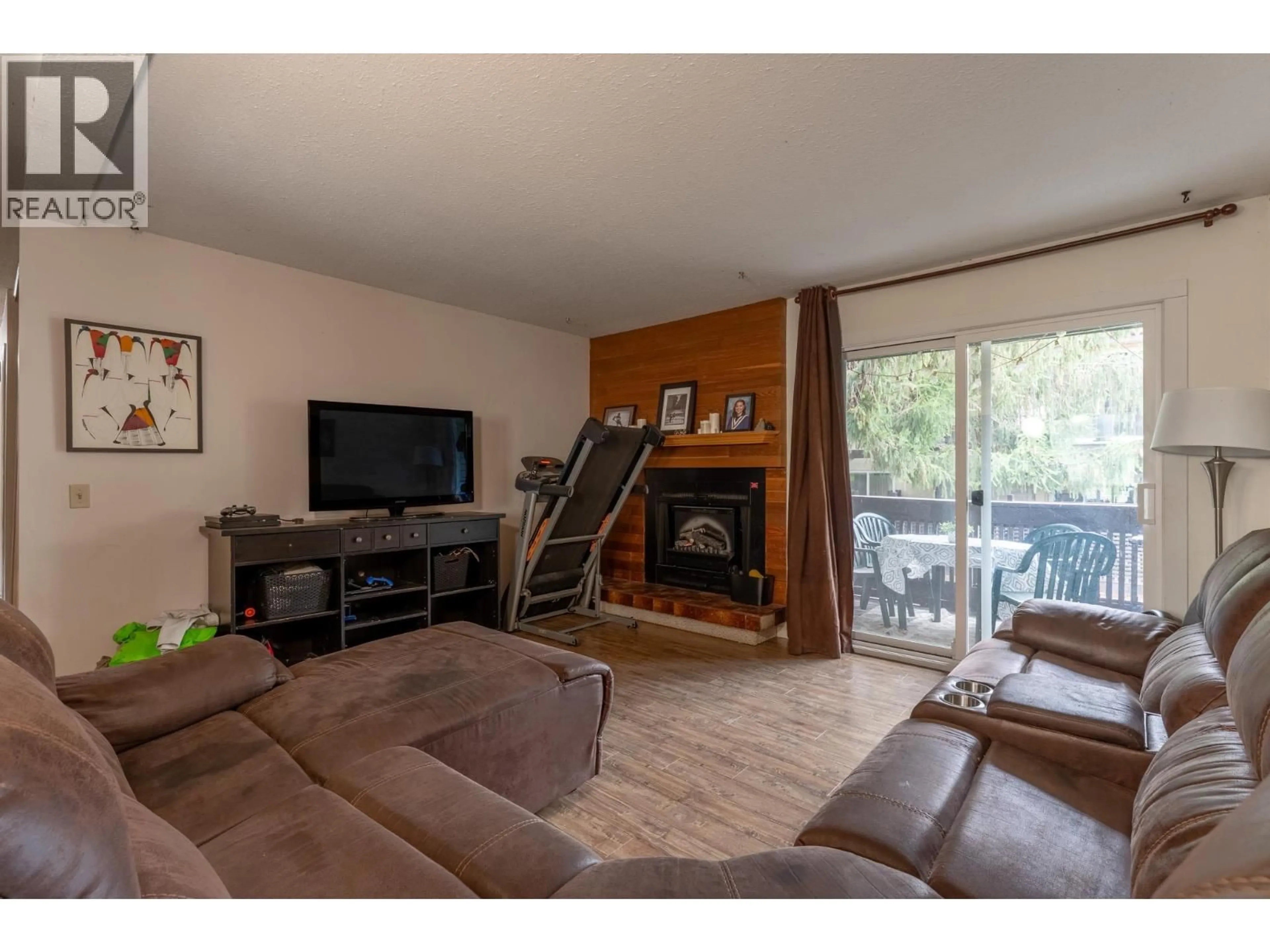 Living room with furniture, wood/laminate floor for 119 - 250 BRIARWOOD ROAD, Kelowna British Columbia V1X2G3