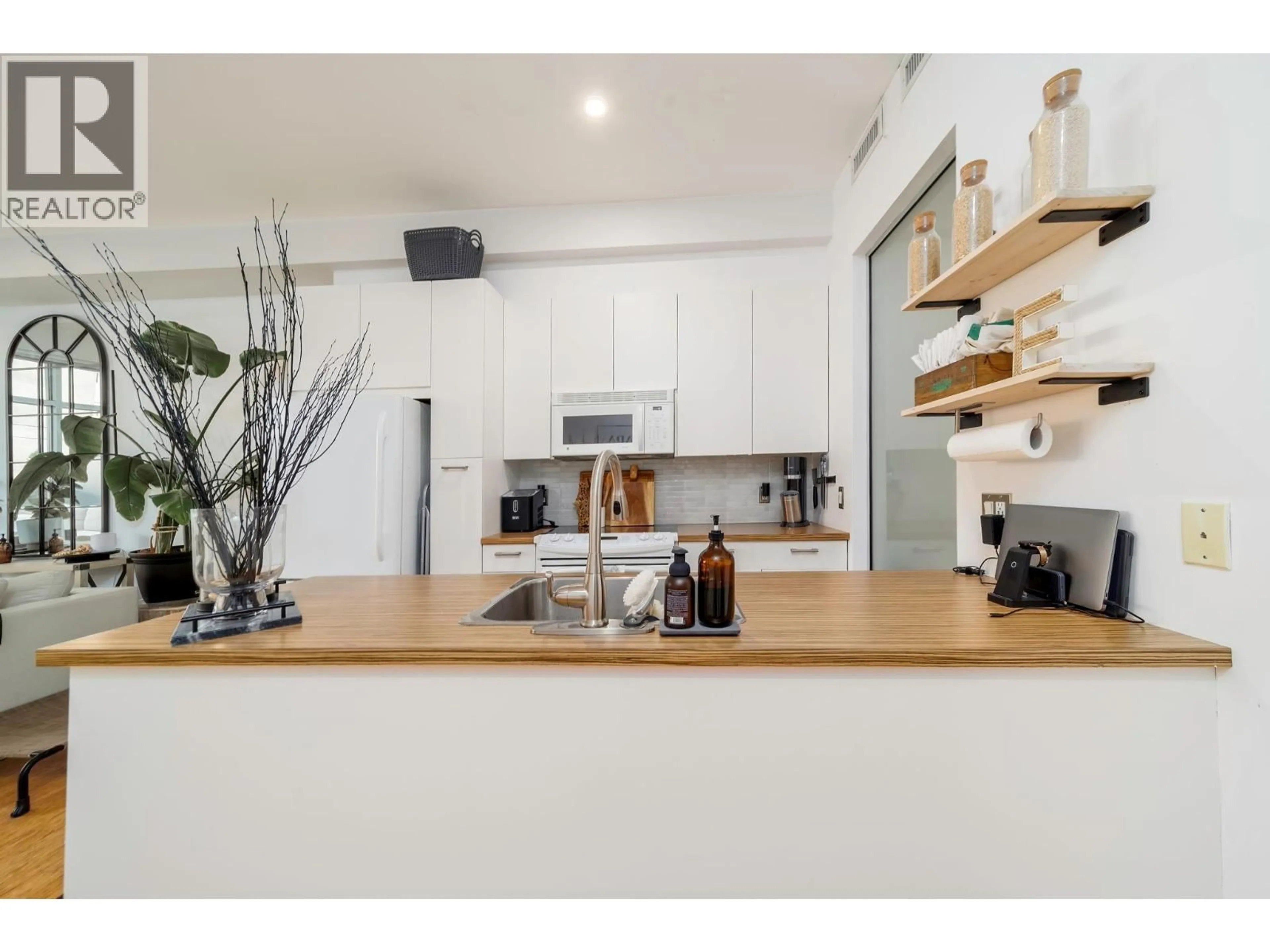 Open concept kitchen, wood/laminate floor for 212 - 1289 ELLIS STREET, Kelowna British Columbia V1Y9X6