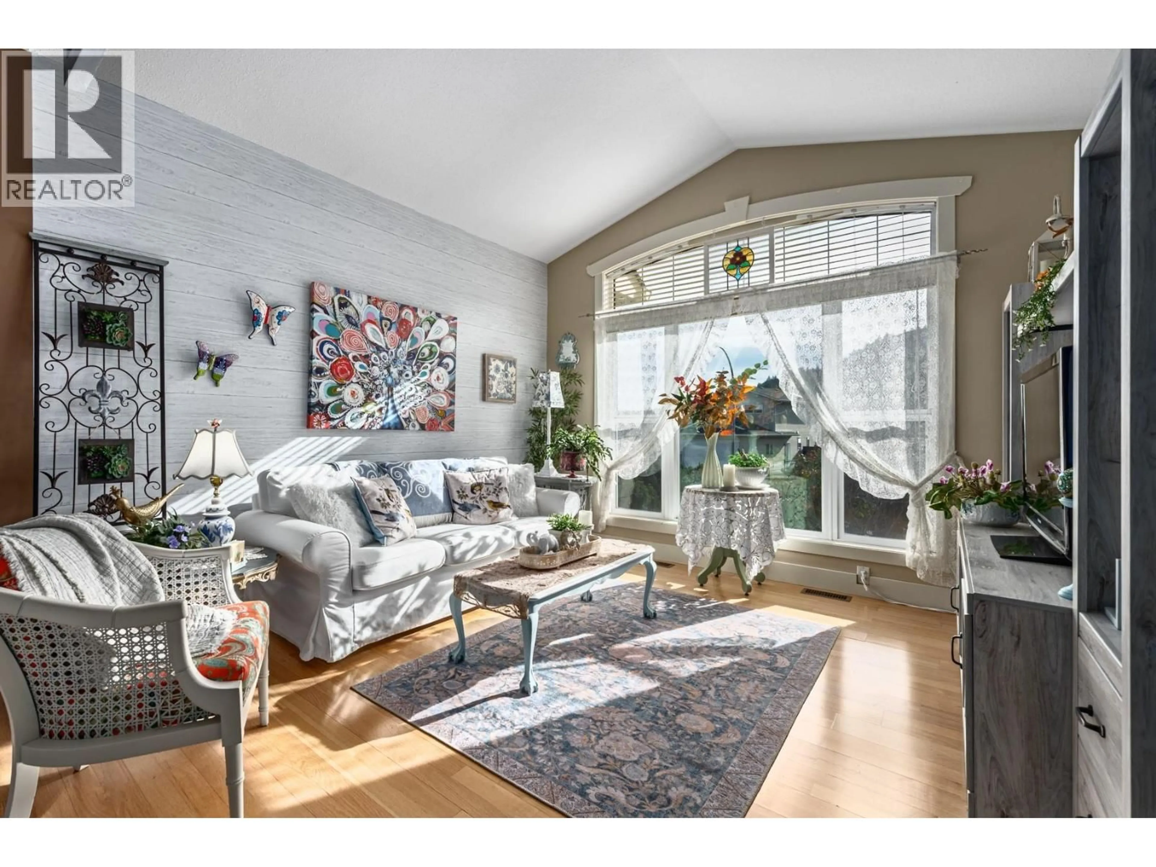 Living room with furniture, wood/laminate floor for 405 COUGAR ROAD, Kamloops British Columbia V2V6V1
