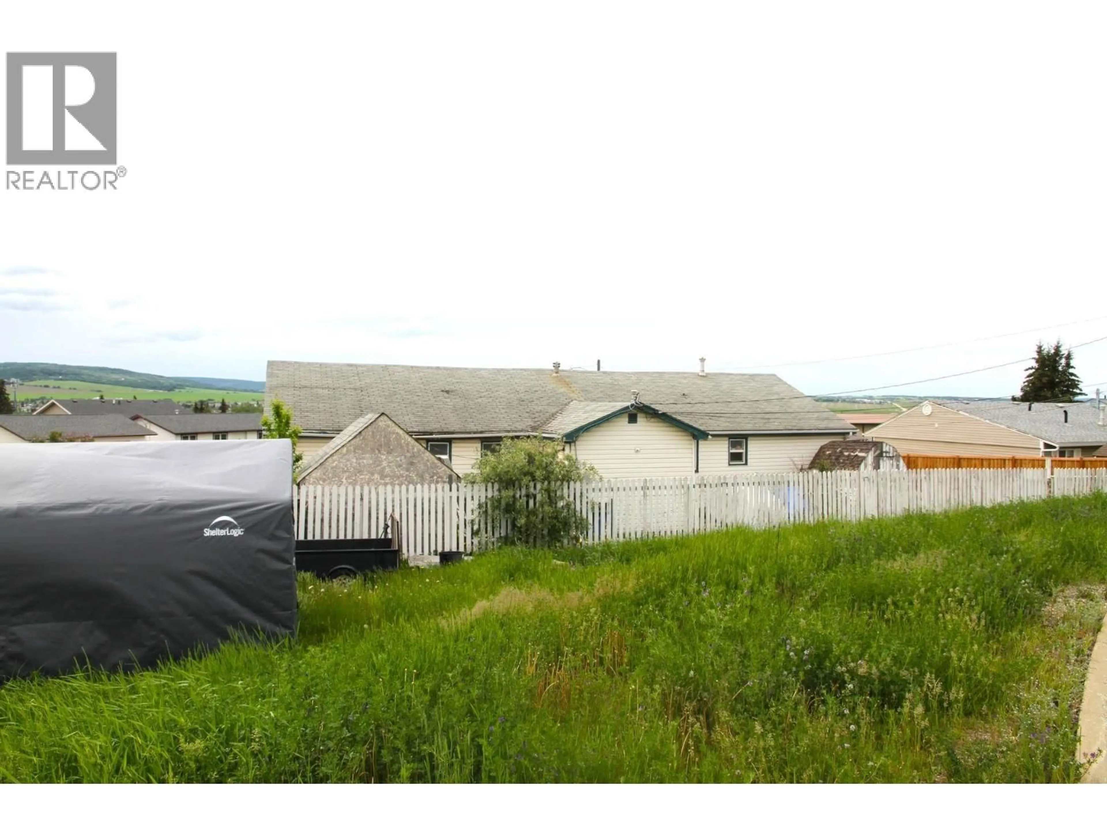 A pic from outside/outdoor area/front of a property/back of a property/a pic from drone, unknown for 900 CORNWALL CRESCENT, Dawson Creek British Columbia V1G1N9