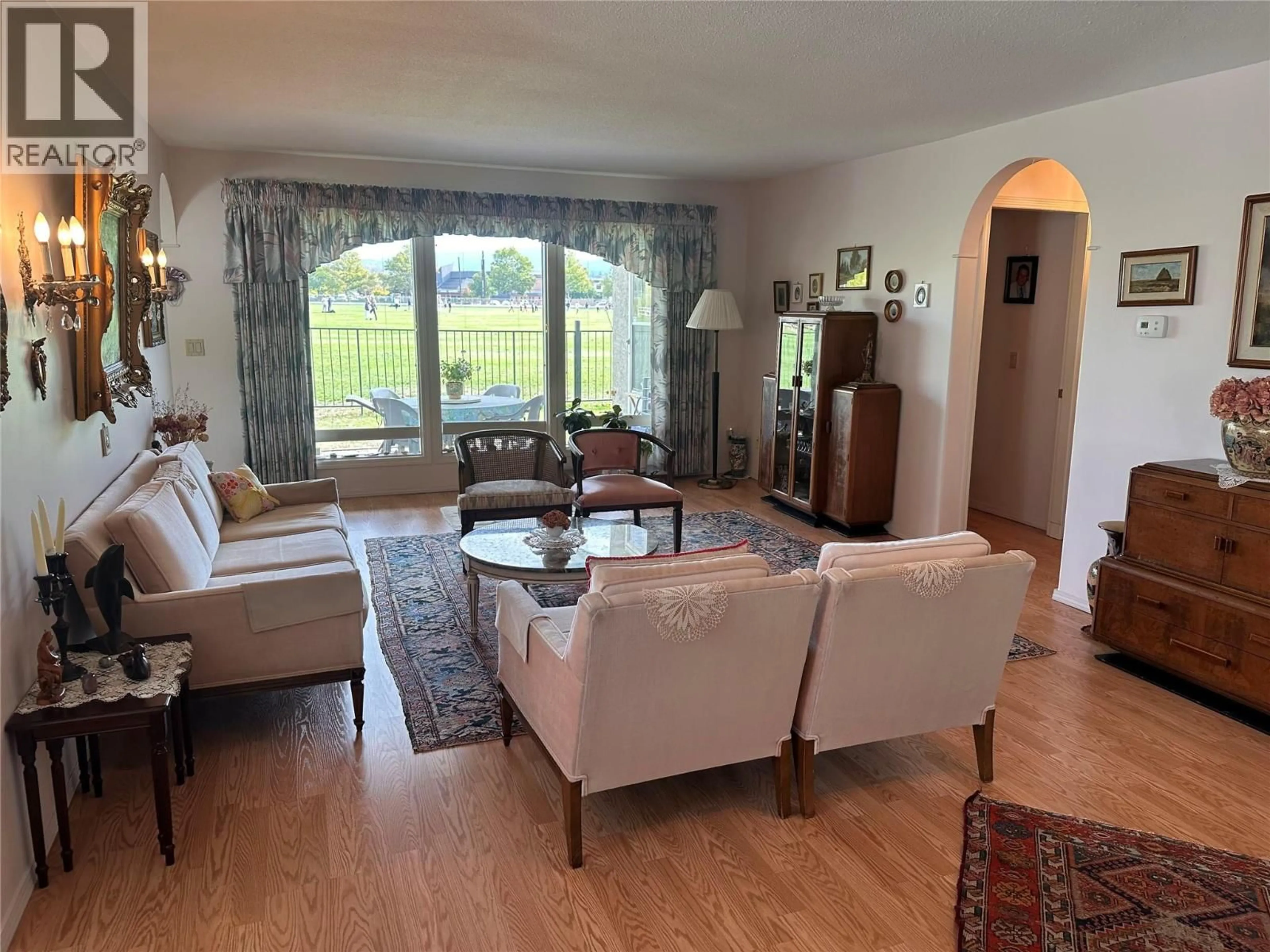 Living room with furniture, wood/laminate floor for 12 - 1020 LANFRANCO ROAD, Kelowna British Columbia V1W3W6