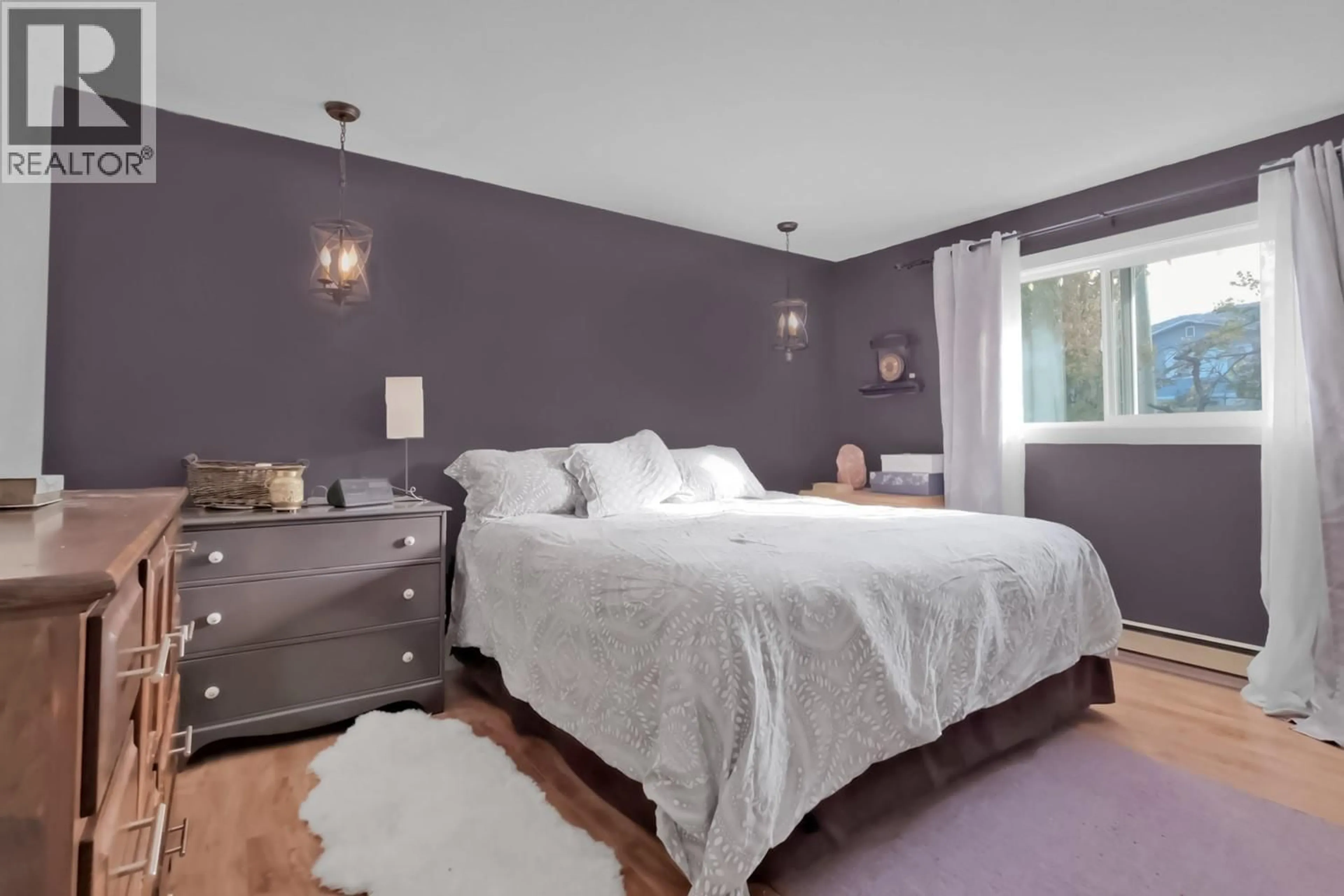 Bedroom with bed, wood/laminate floor for 1575 COLUMBIA STREET, Penticton British Columbia V2A3Y2