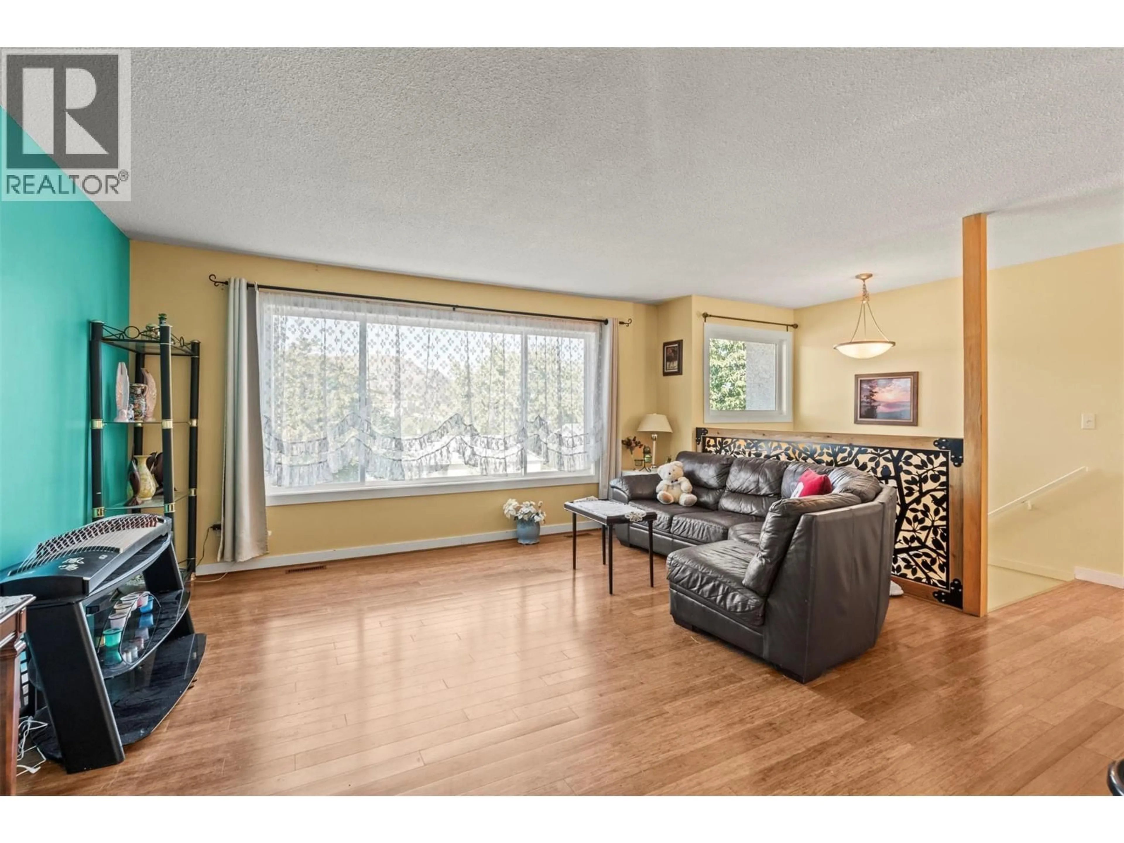 Living room with furniture, wood/laminate floor for 3804 22 AVENUE, Vernon British Columbia V1T1H8