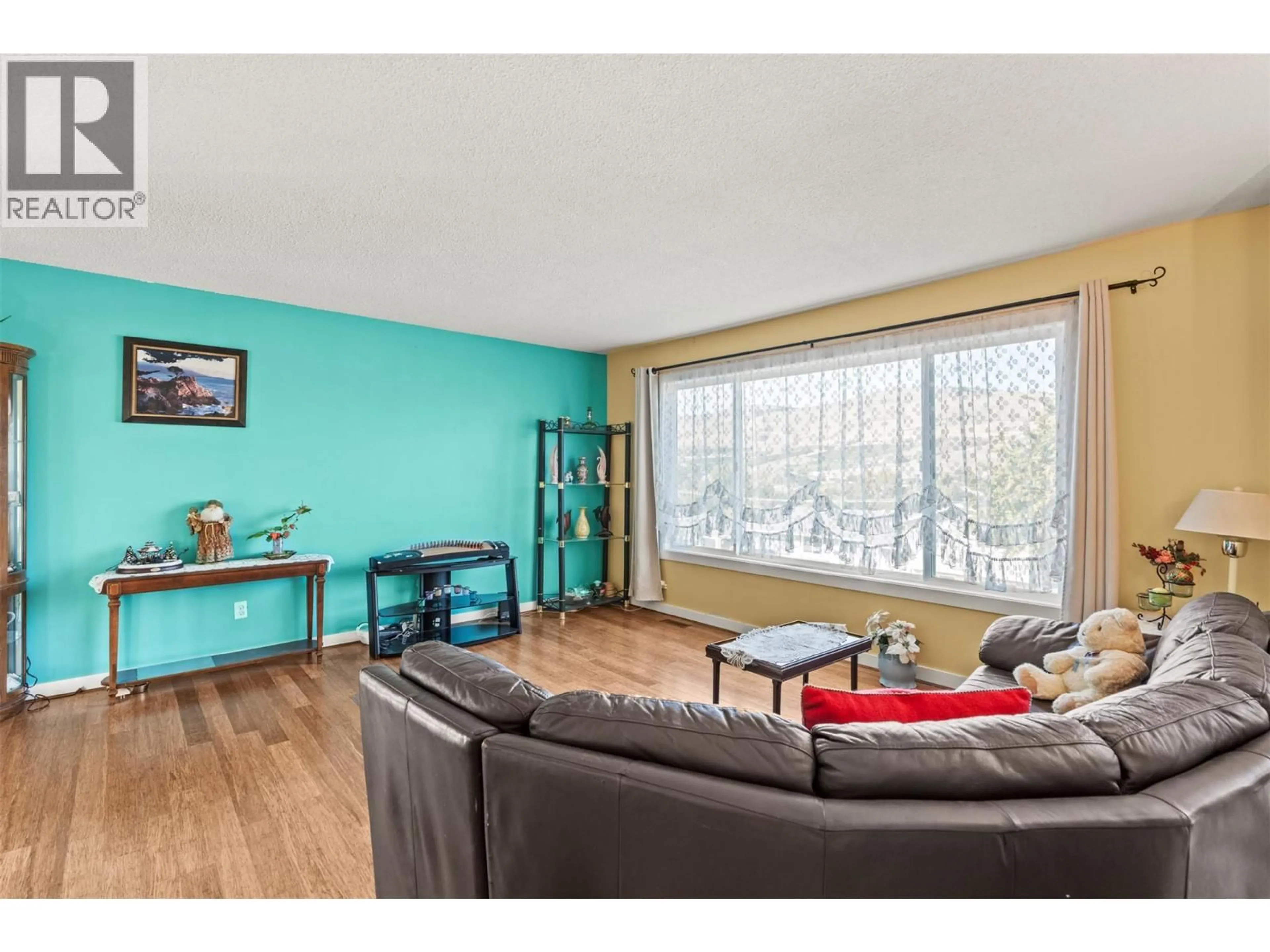 Living room with furniture, wood/laminate floor for 3804 22 AVENUE, Vernon British Columbia V1T1H8