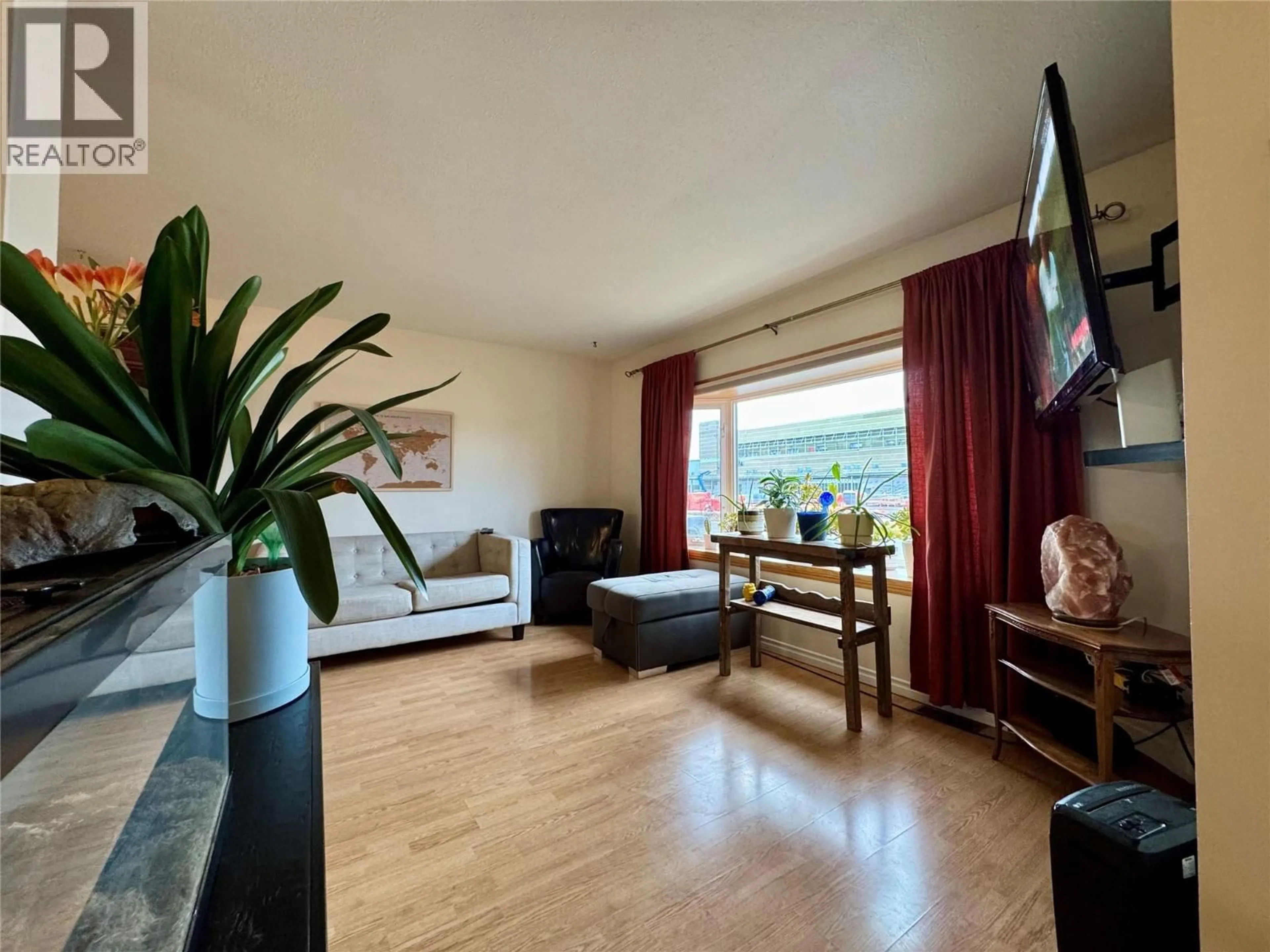 Living room with furniture, wood/laminate floor for 940 112 AVENUE, Dawson Creek British Columbia V1G2Y3