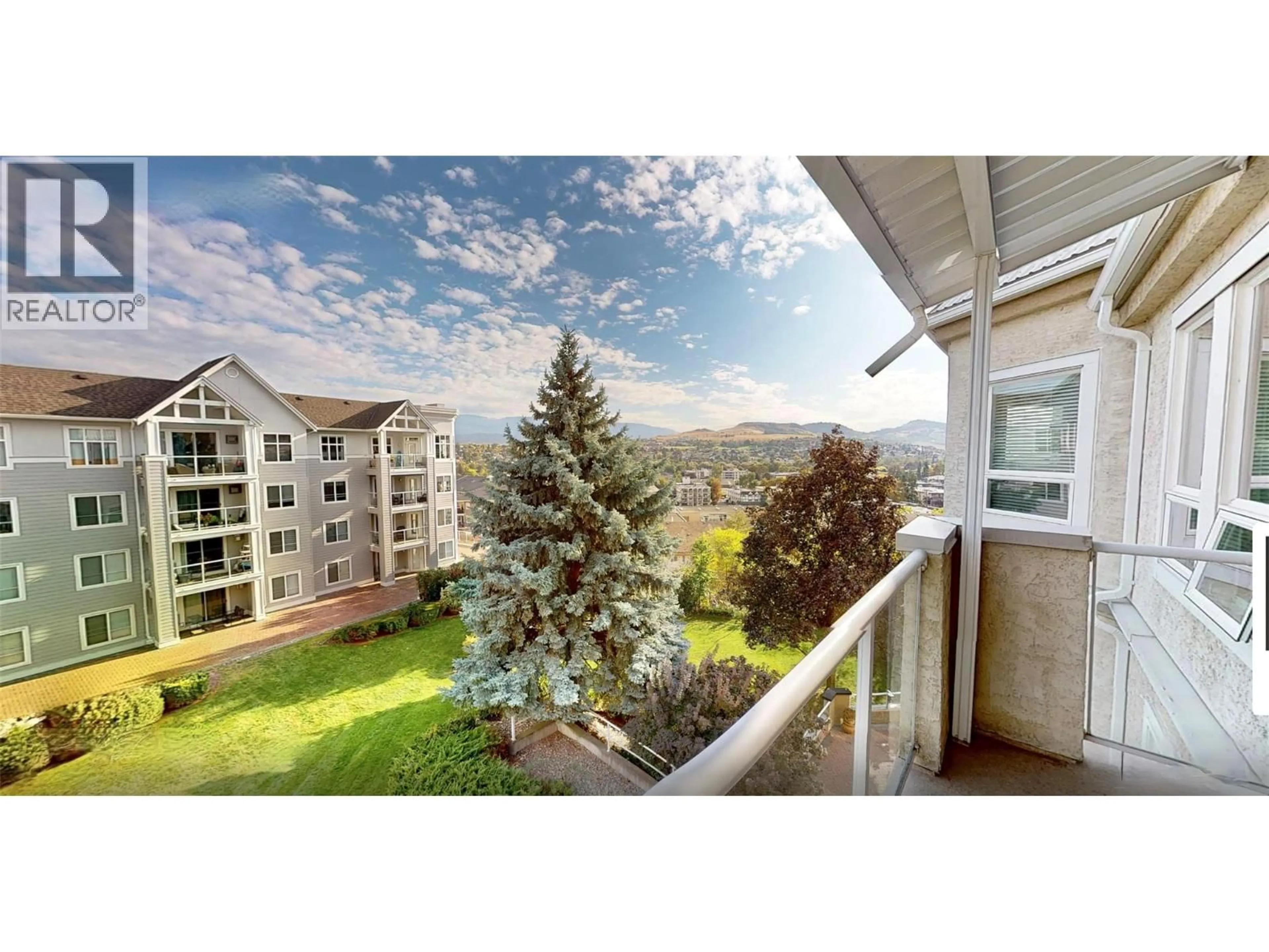Balcony in the apartment, city buildings view from balcony for 411 - 3300 CENTENNIAL DRIVE, Vernon British Columbia V1T9M5
