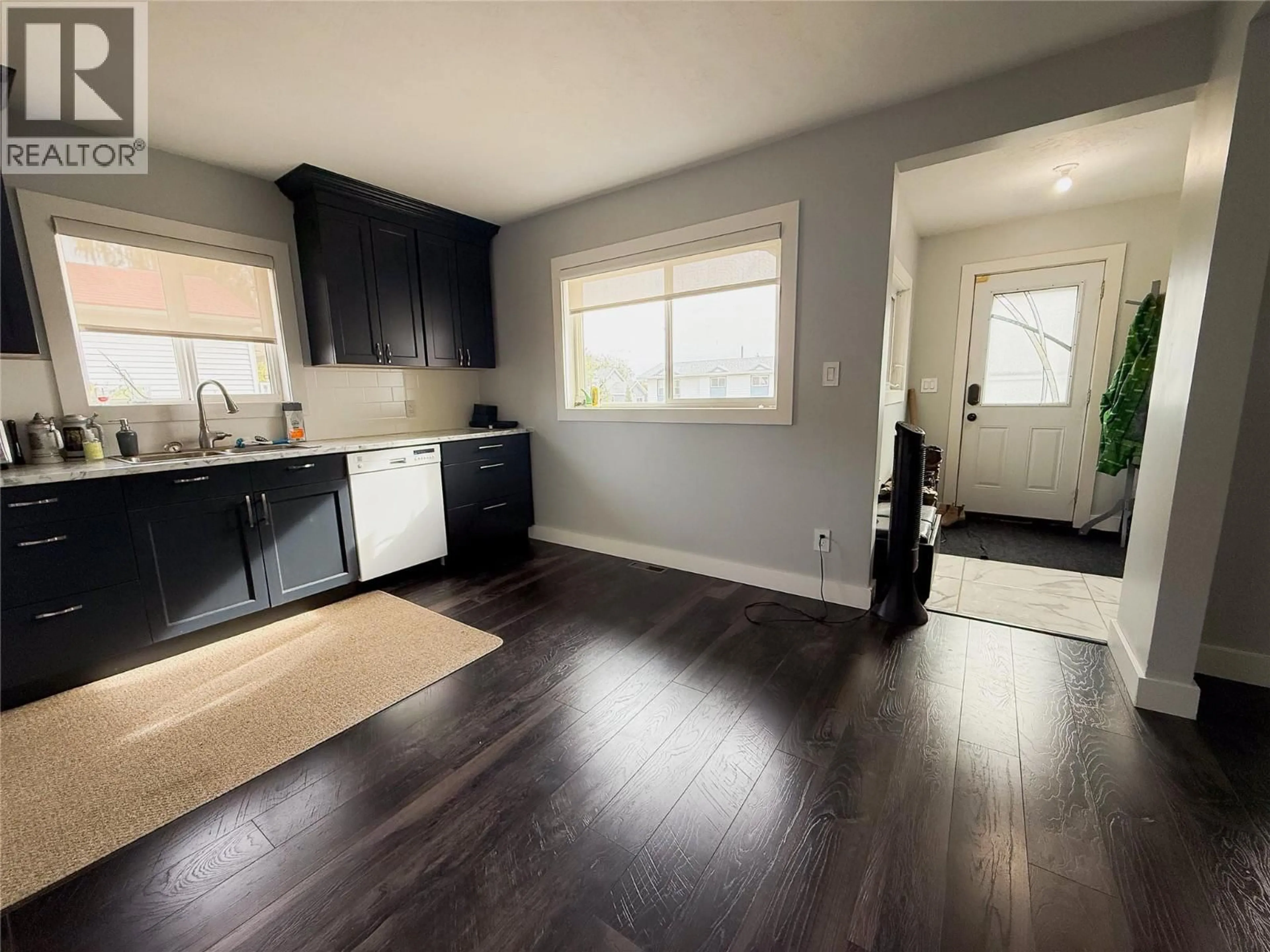 Open concept kitchen, wood/laminate floor for 1156 96A AVENUE, Dawson Creek British Columbia V1G1M8