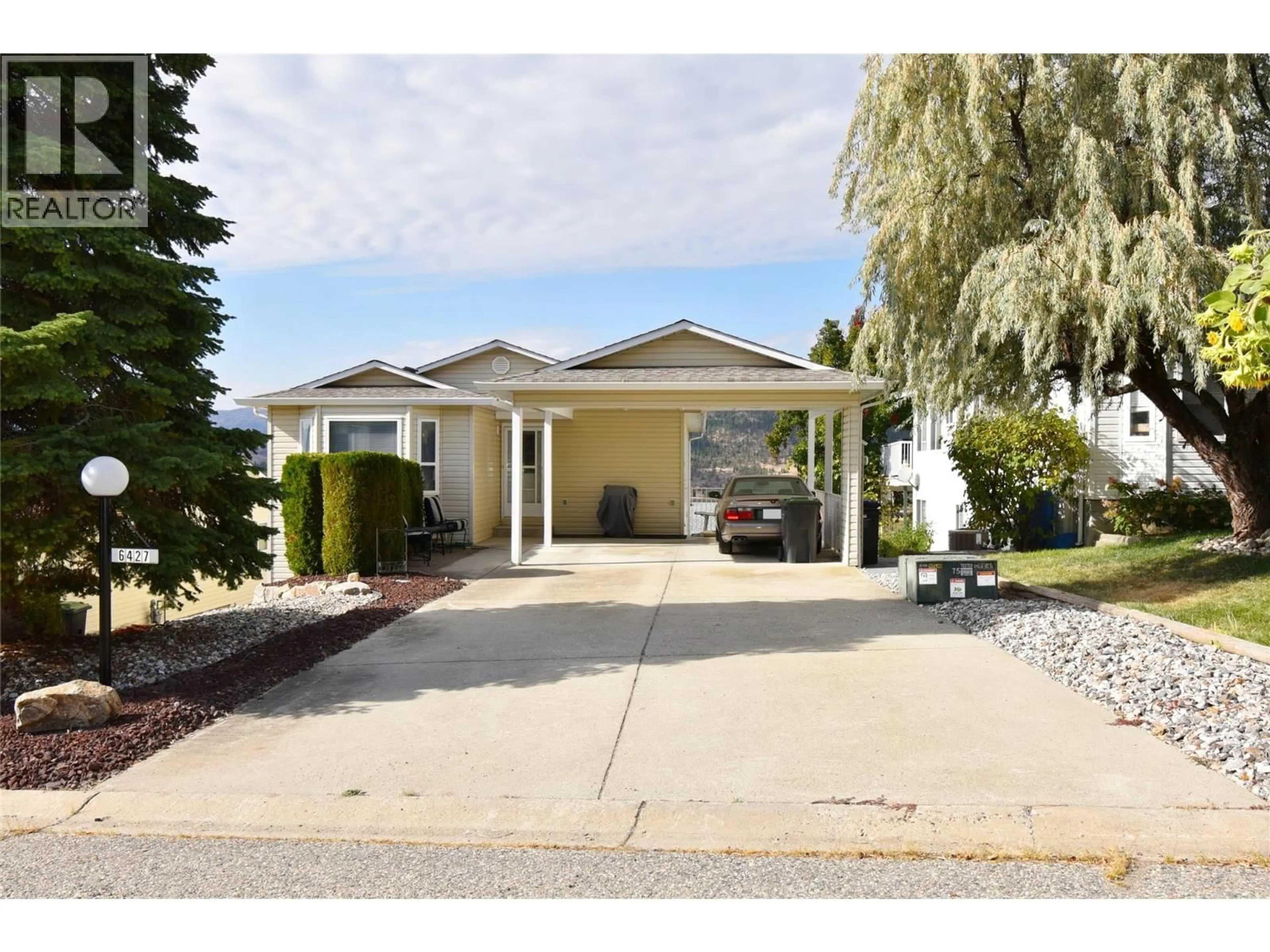 Home with vinyl exterior material, street for 6427 SPENCER ROAD, Kelowna British Columbia V1X7T6