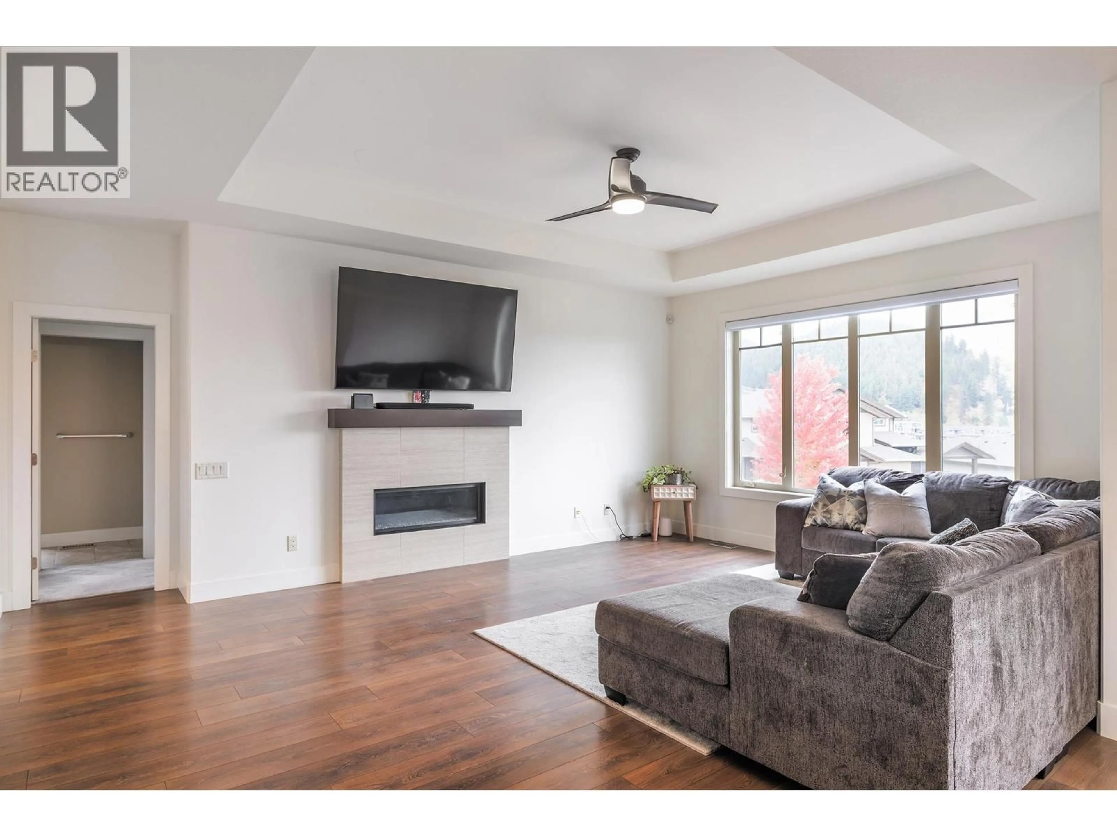 Living room with furniture, wood/laminate floor for 1858 SPLIT RAIL PLACE, Kelowna British Columbia V1P1R1