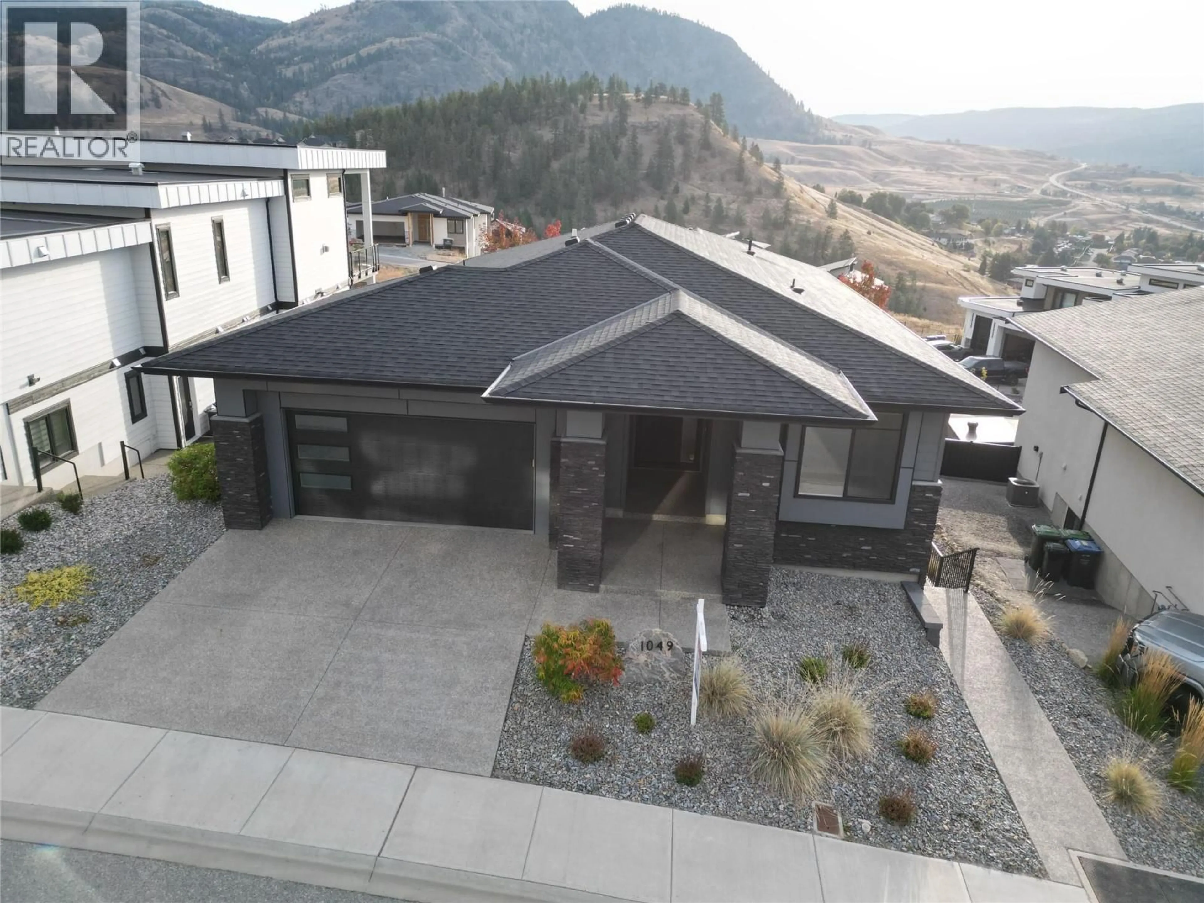 A pic from outside/outdoor area/front of a property/back of a property/a pic from drone, mountain view for 1049 LOSETH DRIVE, Kelowna British Columbia V1P0A1