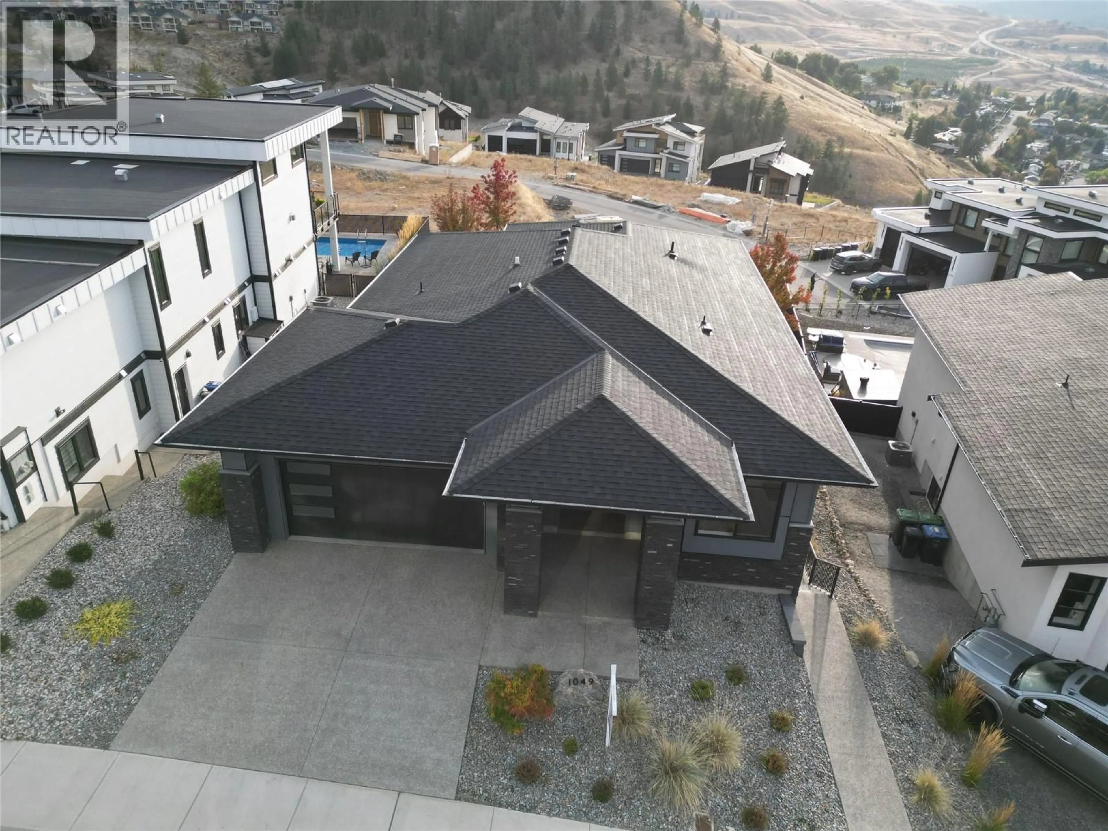 A pic from outside/outdoor area/front of a property/back of a property/a pic from drone, mountain view for 1049 LOSETH DRIVE, Kelowna British Columbia V1P0A1