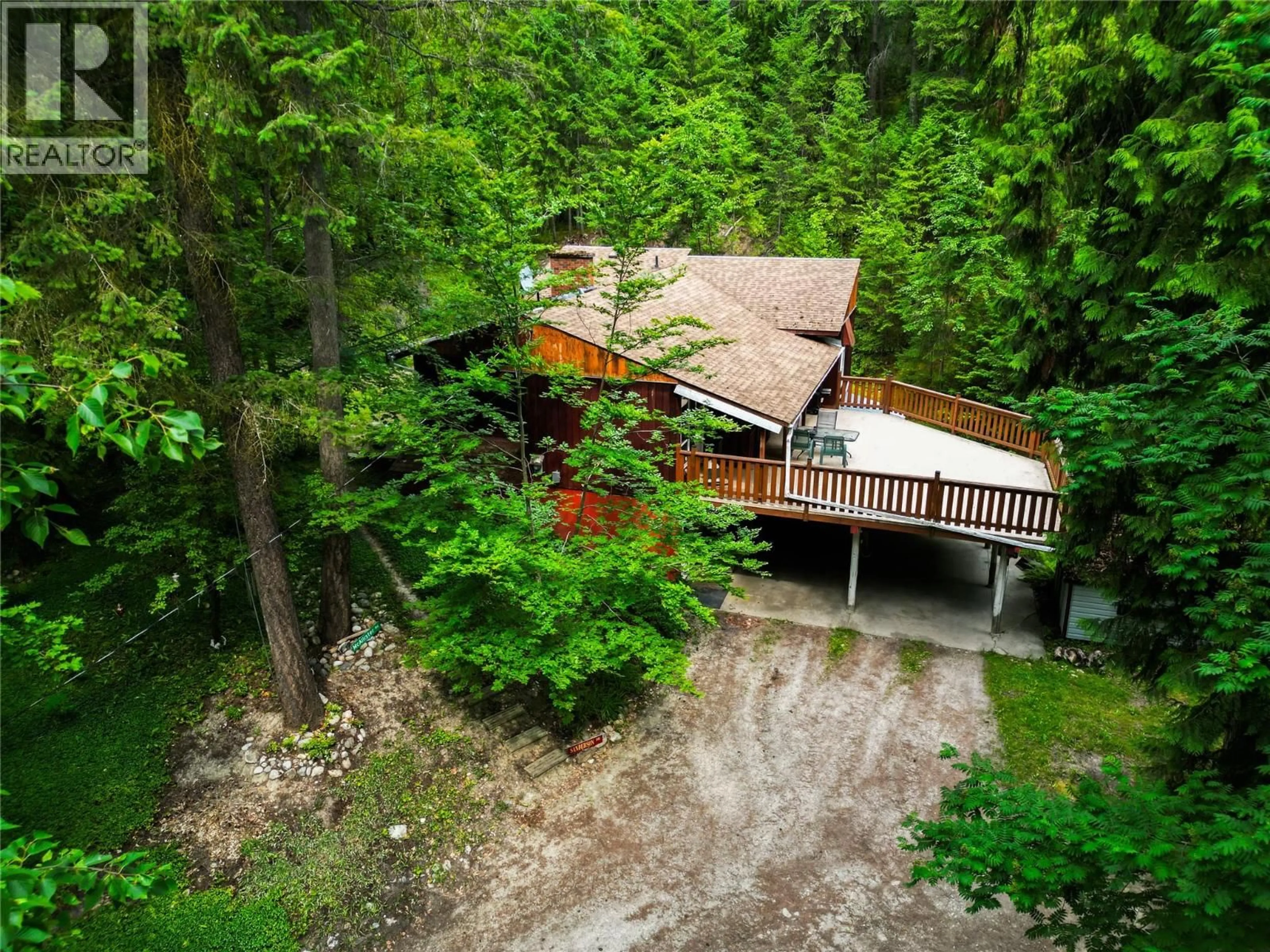 A pic from outside/outdoor area/front of a property/back of a property/a pic from drone, forest/trees view for 8043 97A HIGHWAY, Mara British Columbia V0E2K0