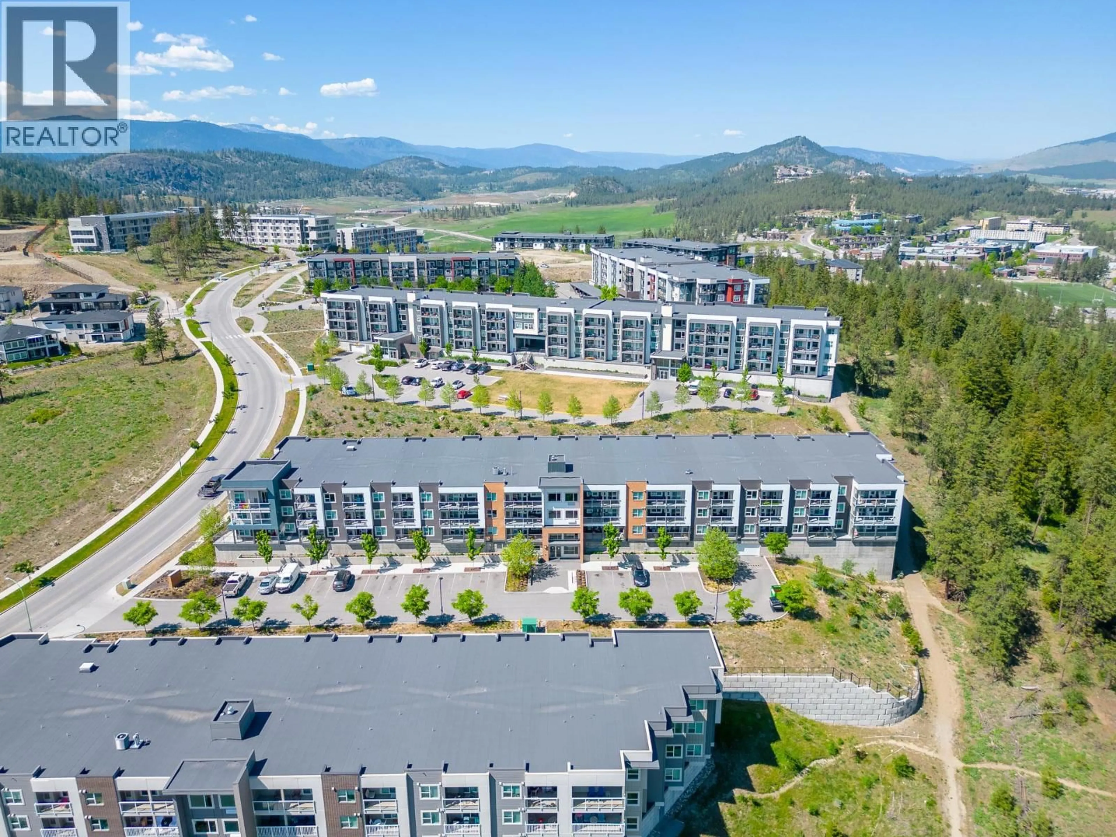 A pic from outside/outdoor area/front of a property/back of a property/a pic from drone, mountain view for 203 - 725 ACADEMY WAY, Kelowna British Columbia V1V0B4