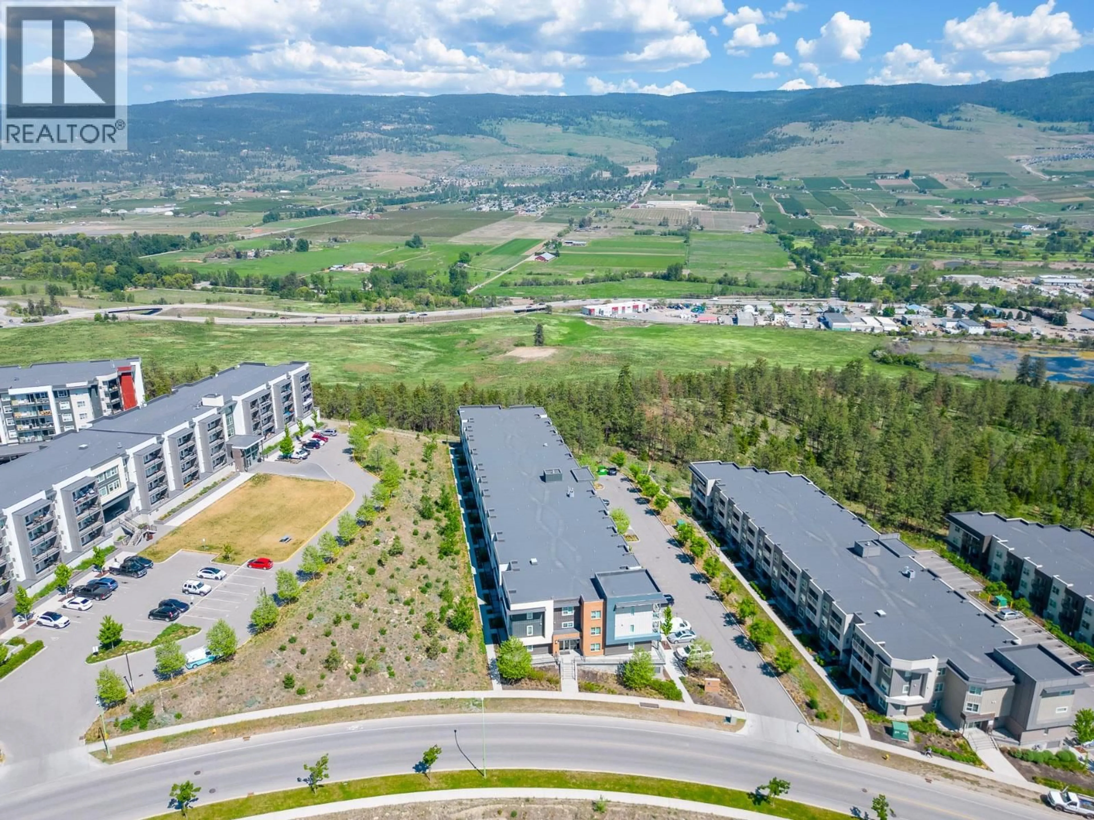 A pic from outside/outdoor area/front of a property/back of a property/a pic from drone, mountain view for 203 - 725 ACADEMY WAY, Kelowna British Columbia V1V0B4
