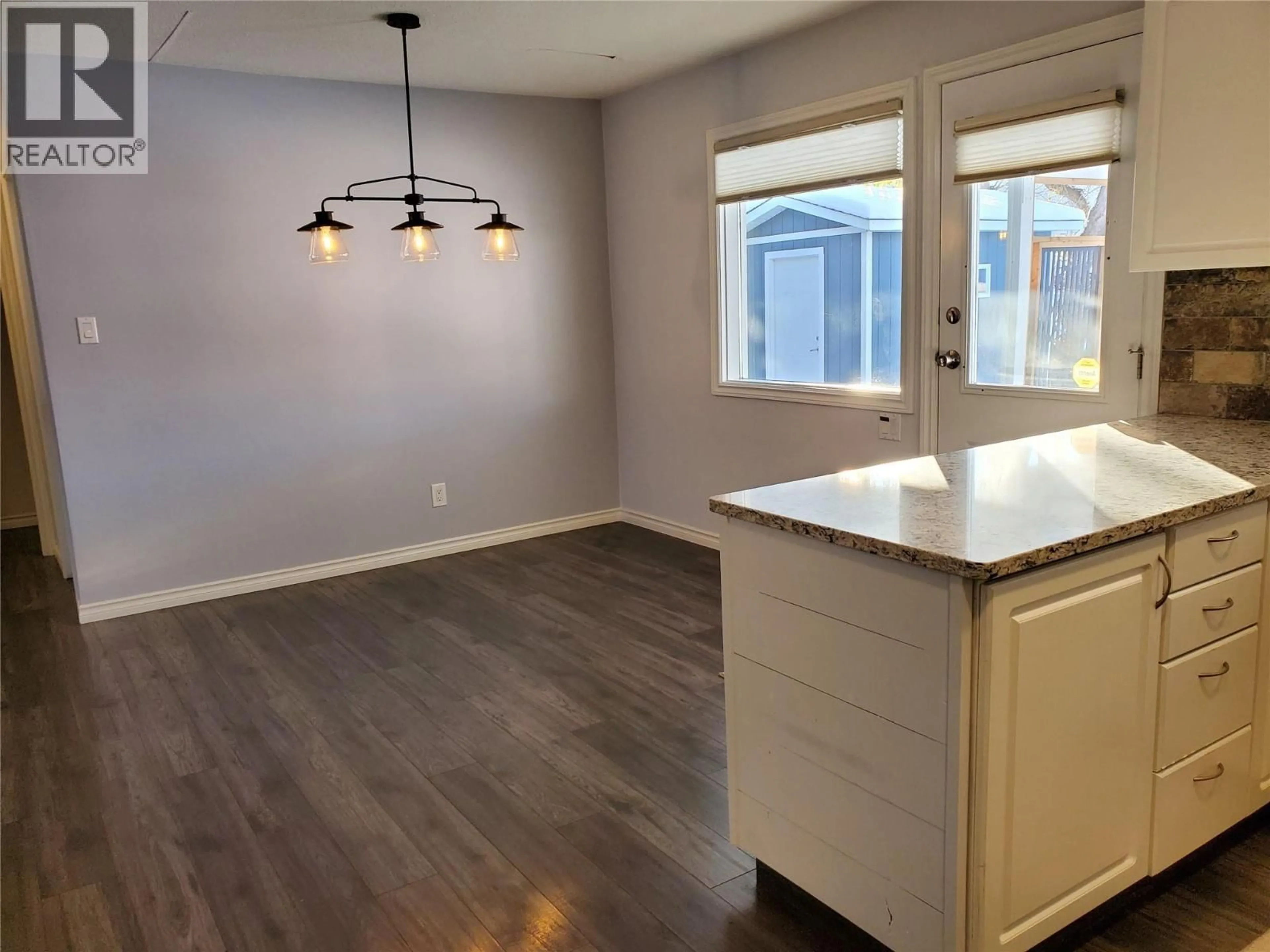 Open concept kitchen, wood/laminate floor for 1700 30 STREET, Vernon British Columbia V1T5C3