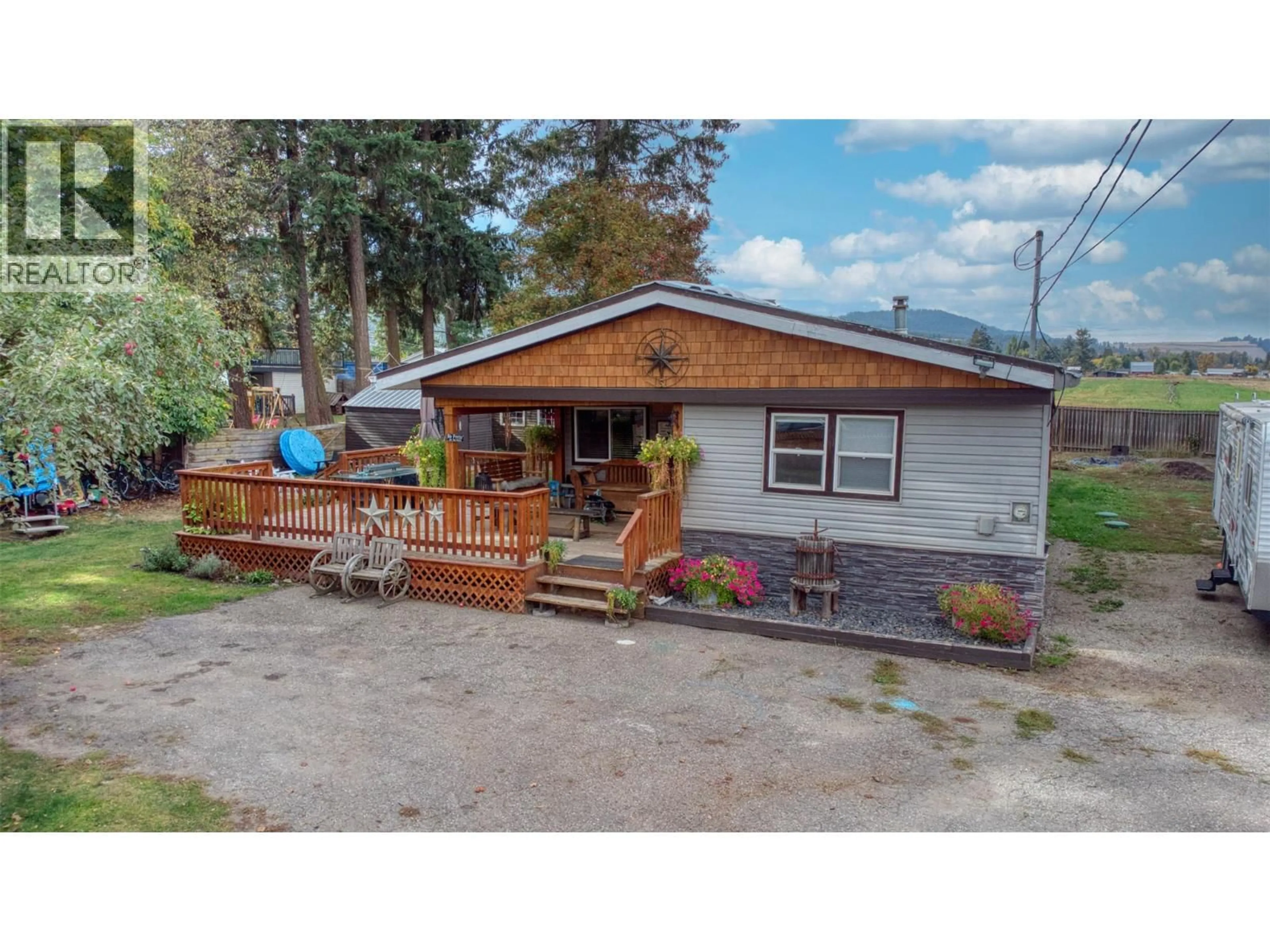 A pic from outside/outdoor area/front of a property/back of a property/a pic from drone, street for 718 FRASER ROAD, Lumby British Columbia V0E2G7