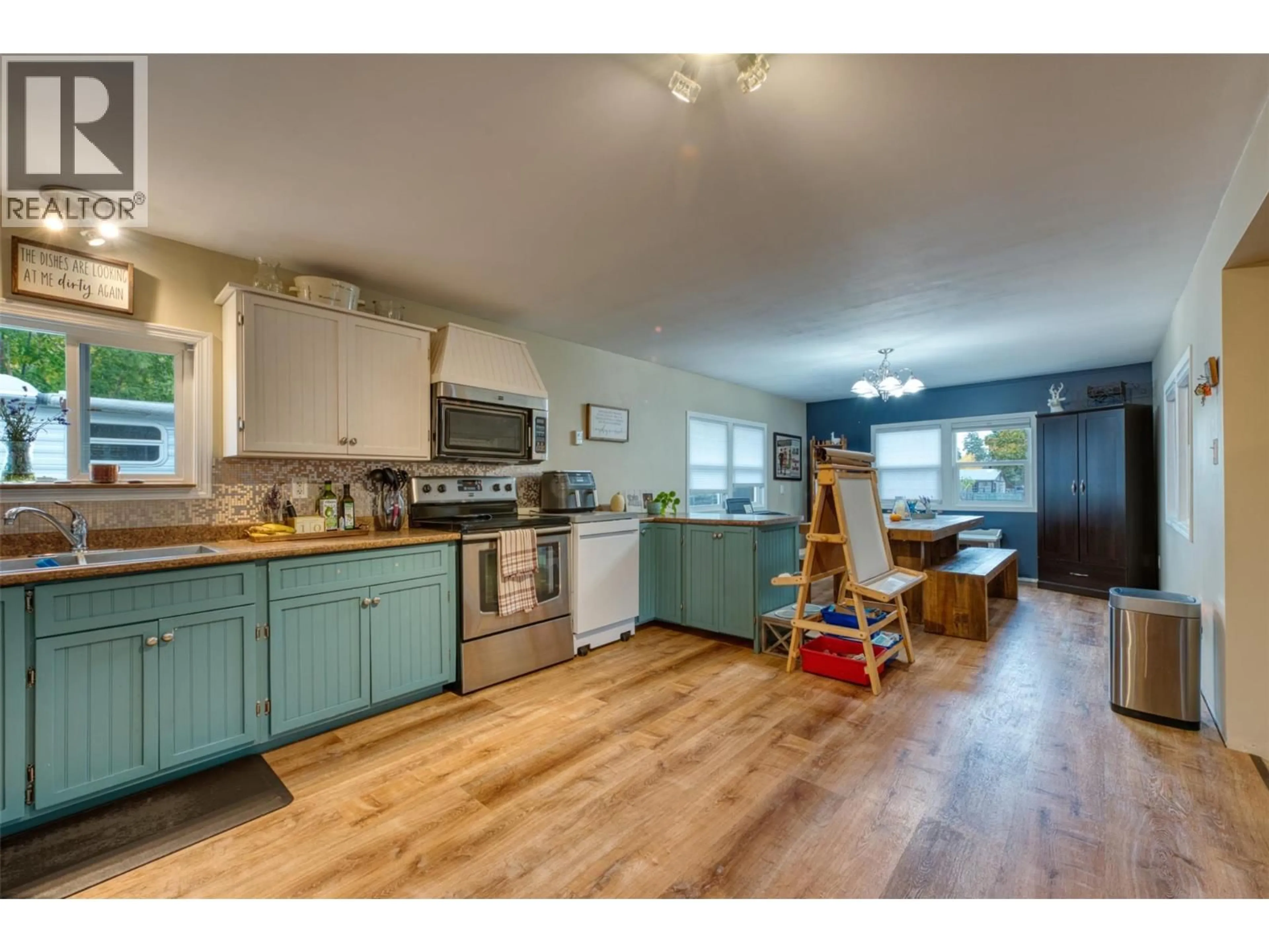 Open concept kitchen, wood/laminate floor for 718 FRASER ROAD, Lumby British Columbia V0E2G7