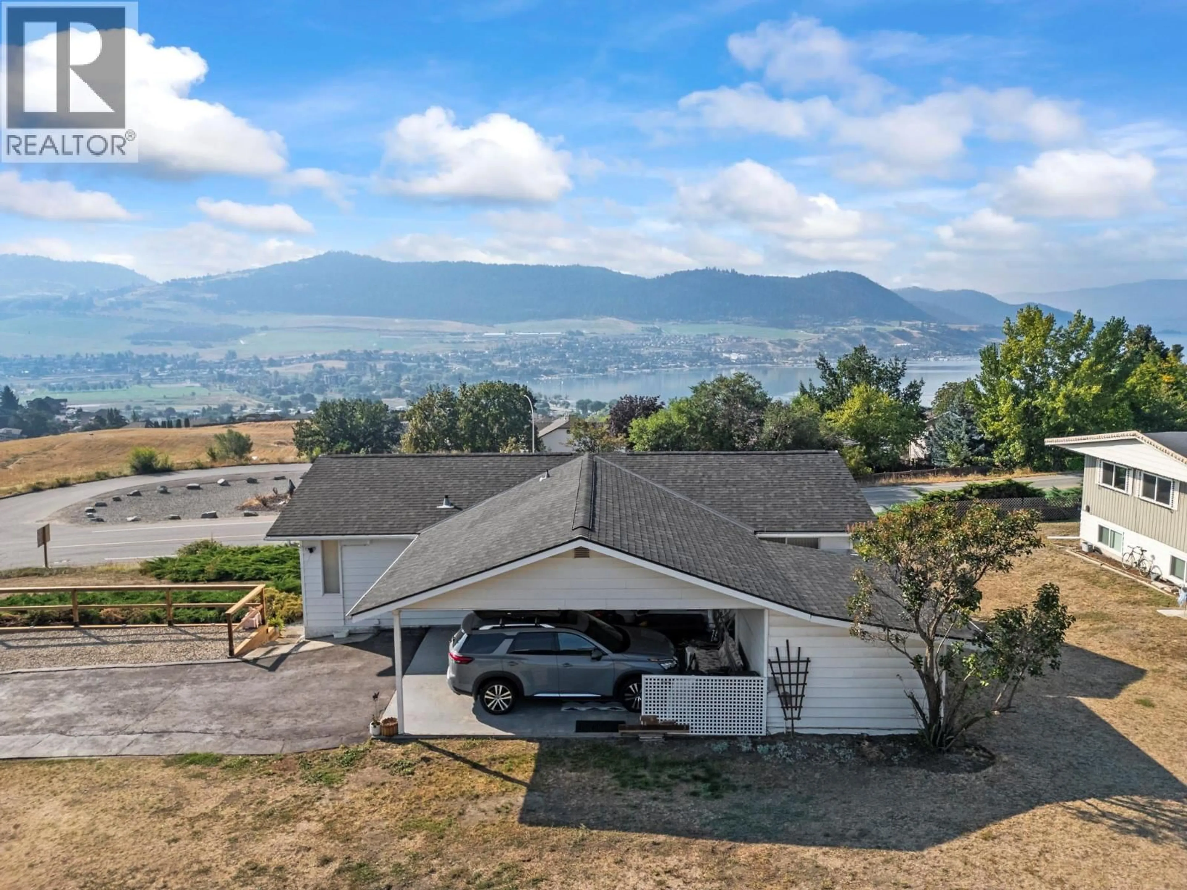 A pic from outside/outdoor area/front of a property/back of a property/a pic from drone, mountain view for 7002 APPALOOSA WAY, Vernon British Columbia V1H1B9