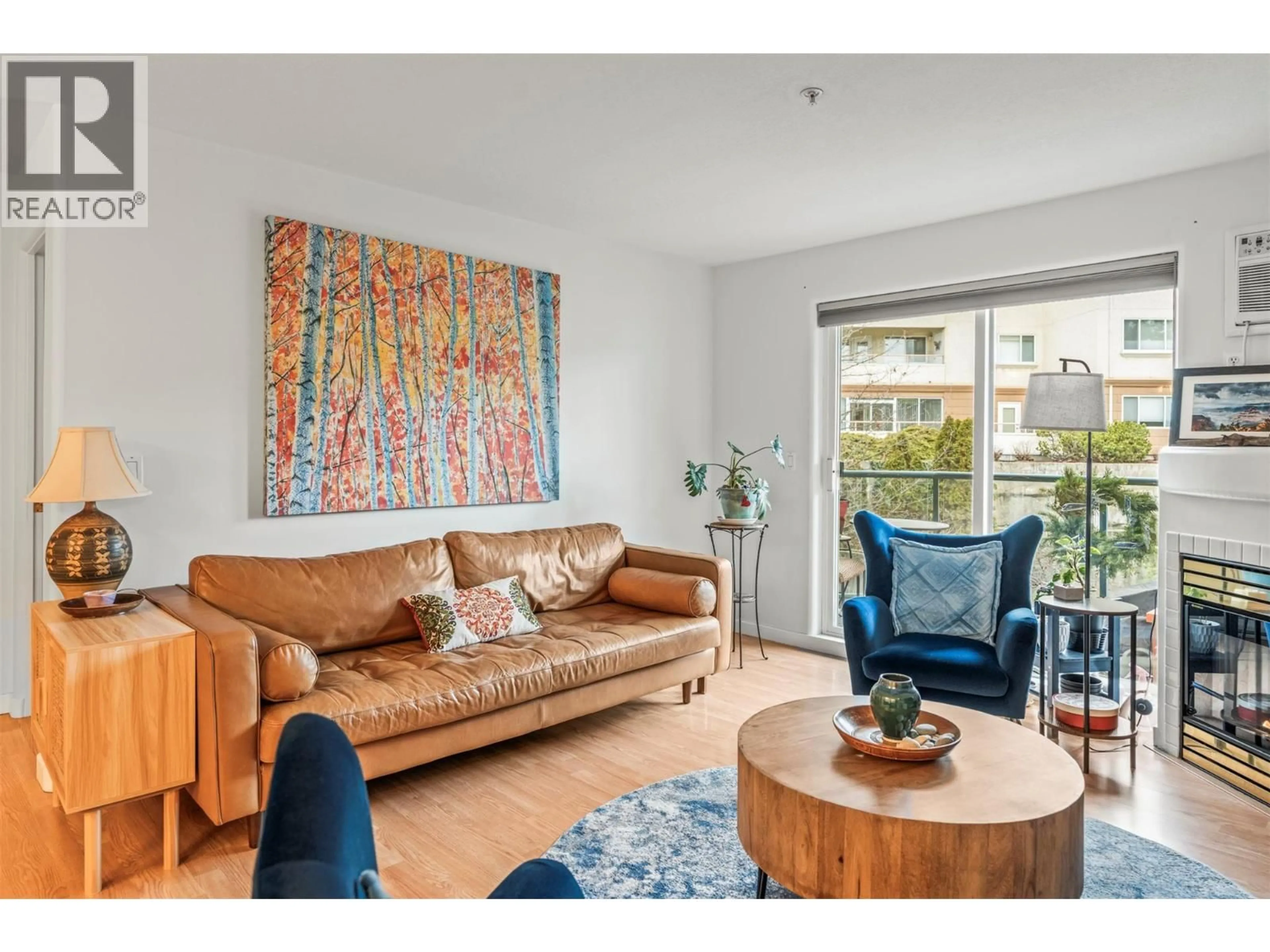 Living room with furniture, wood/laminate floor for 303 - 3221 CENTENNIAL DRIVE, Vernon British Columbia V1T2T8