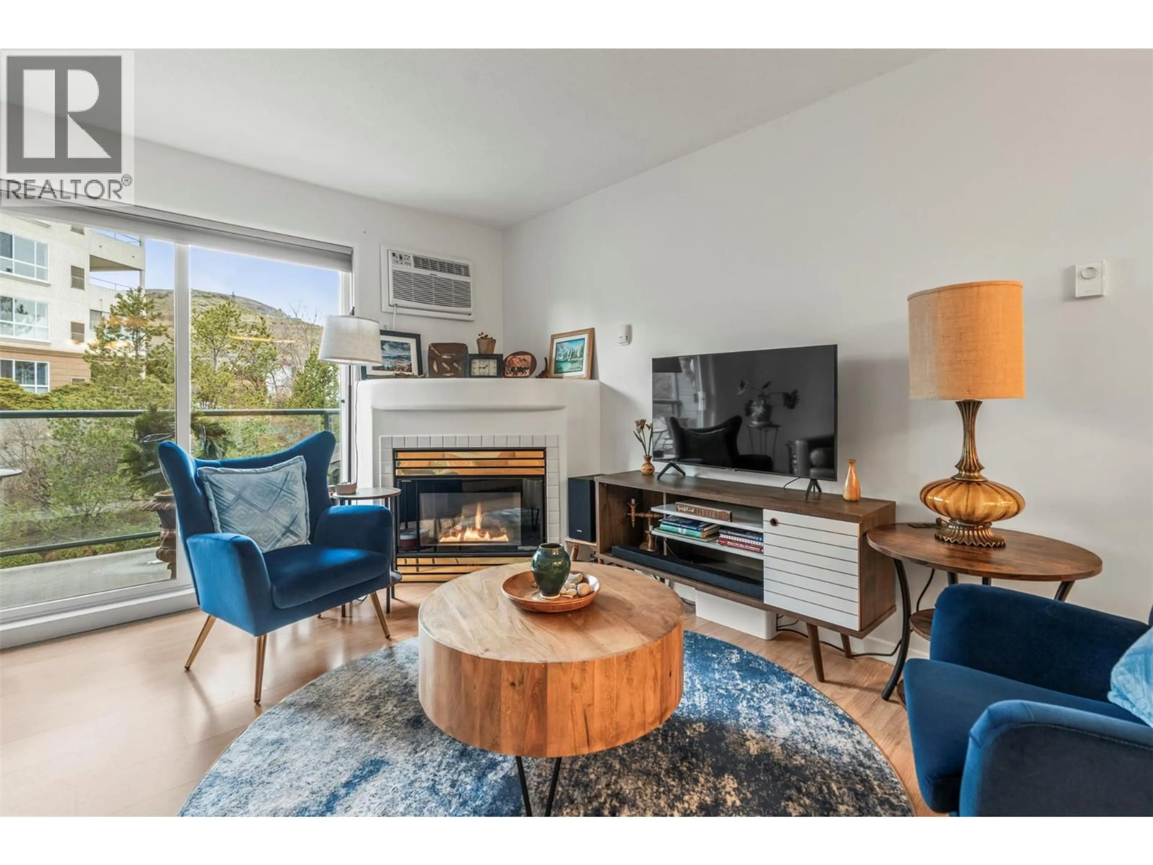 Living room with furniture, wood/laminate floor for 303 - 3221 CENTENNIAL DRIVE, Vernon British Columbia V1T2T8