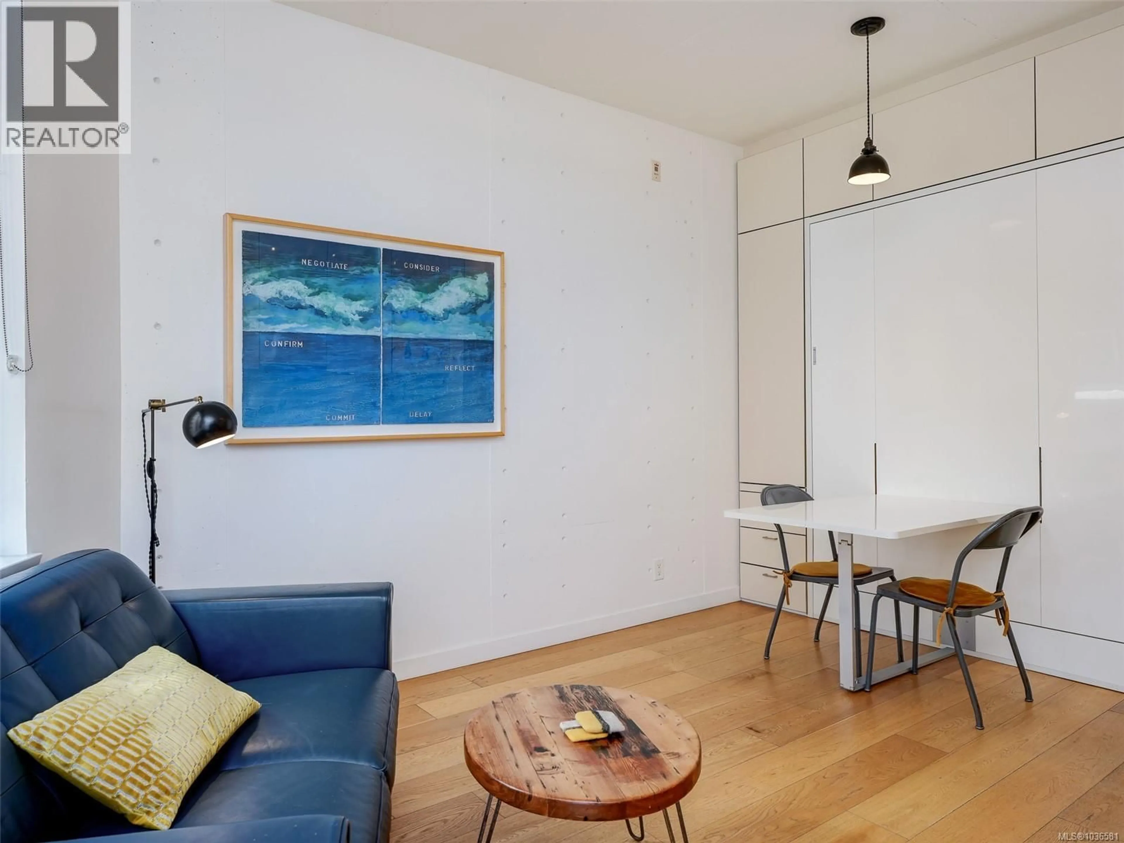 Living room with furniture, wood/laminate floor for 210 - 456 PANDORA AVENUE, Victoria British Columbia V8W0E3