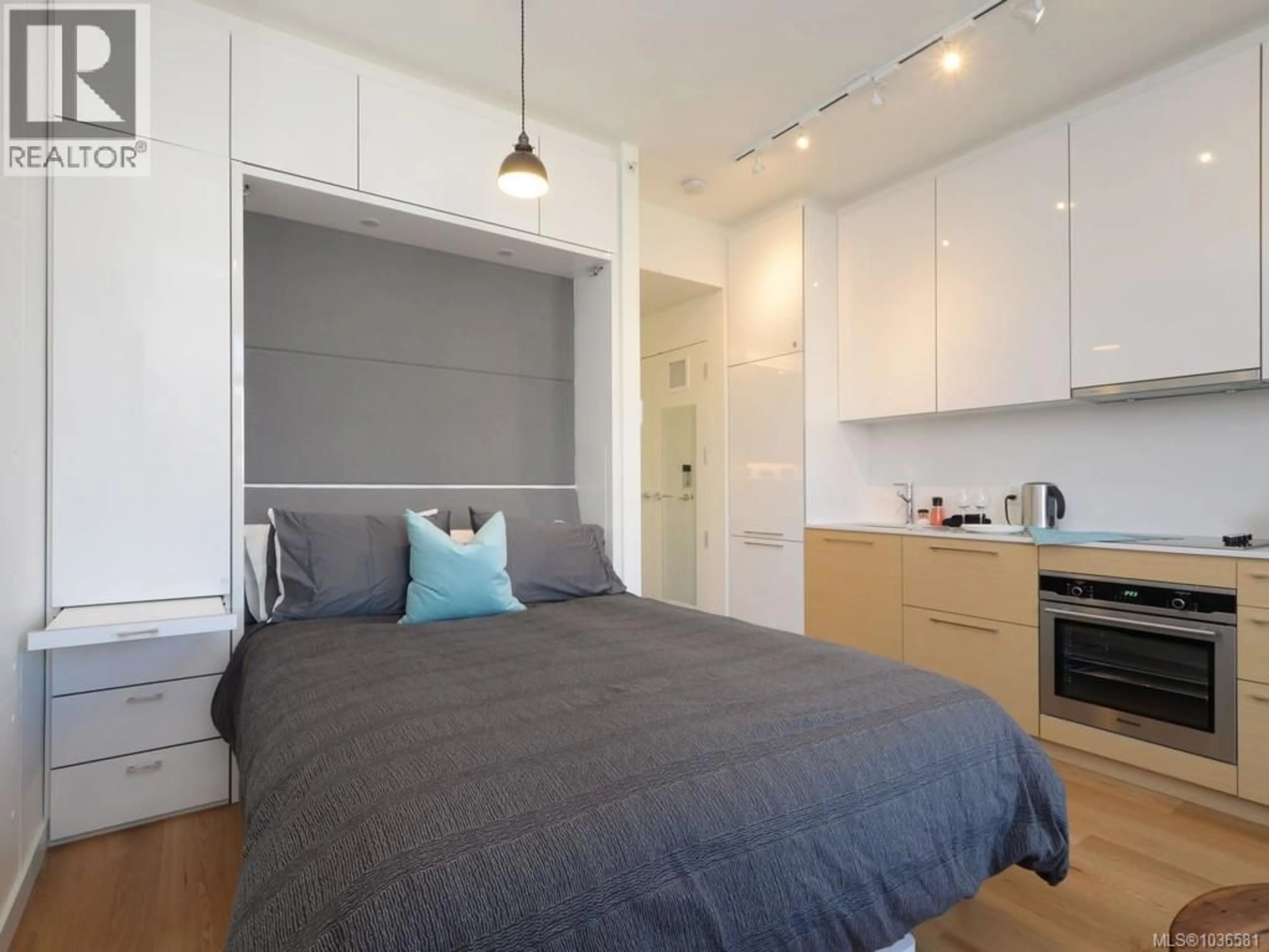 Bedroom with bed, wood/laminate floor for 210 - 456 PANDORA AVENUE, Victoria British Columbia V8W0E3