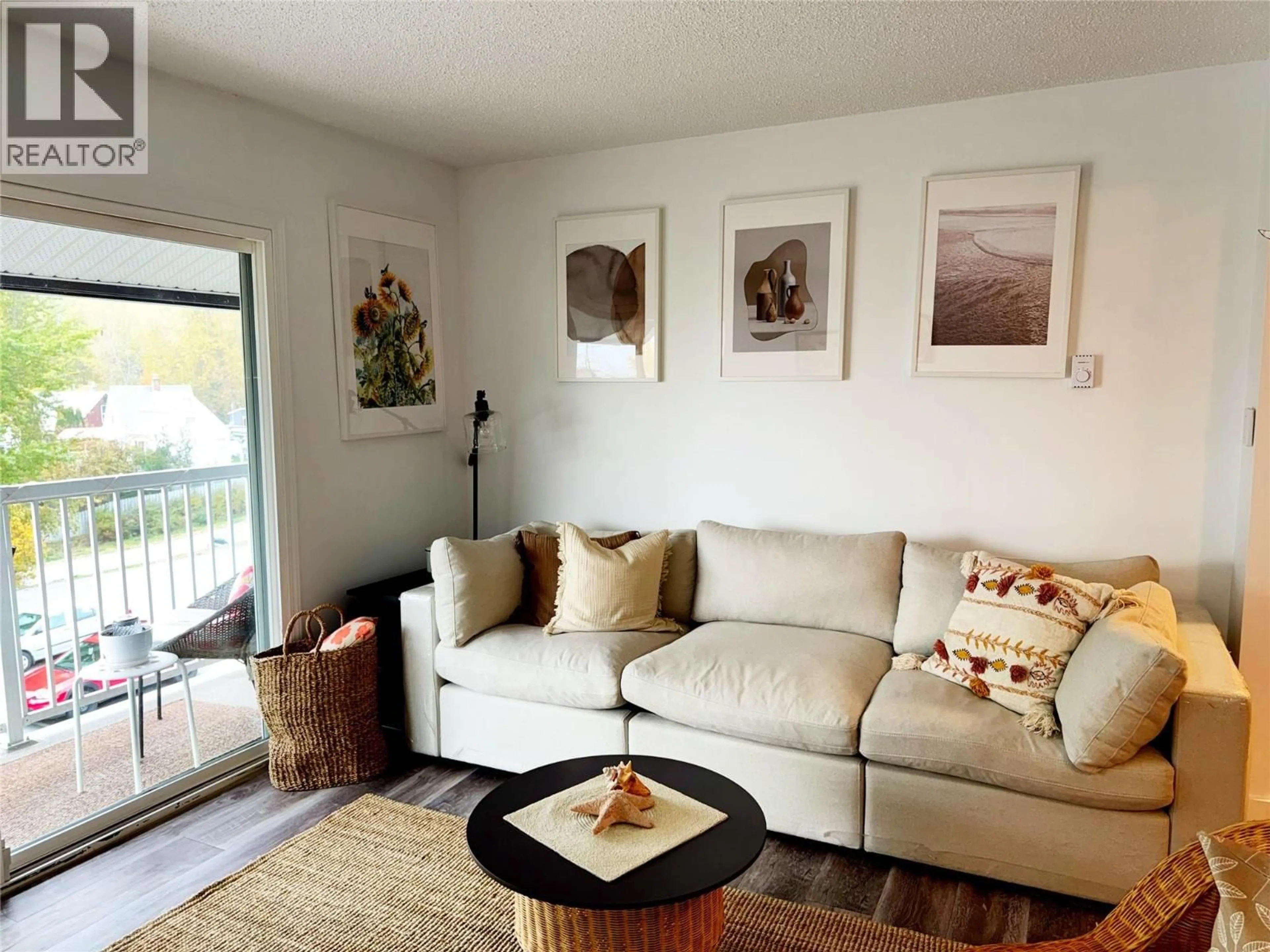Living room with furniture, wood/laminate floor for 304 - 880 WORDSWORTH AVENUE, Warfield British Columbia V1R2E9