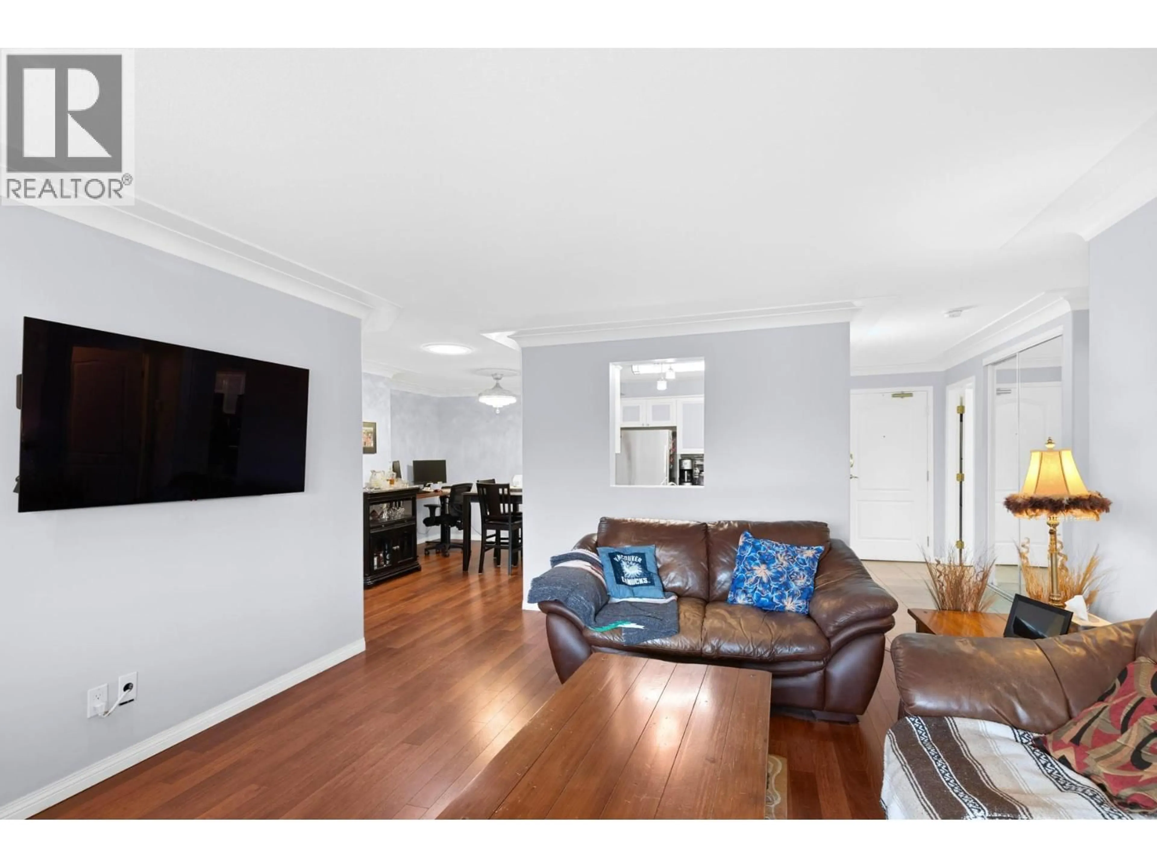 Living room with furniture, wood/laminate floor for 403 - 1964 ENTERPRISE WAY, Kelowna British Columbia V1Y9S5