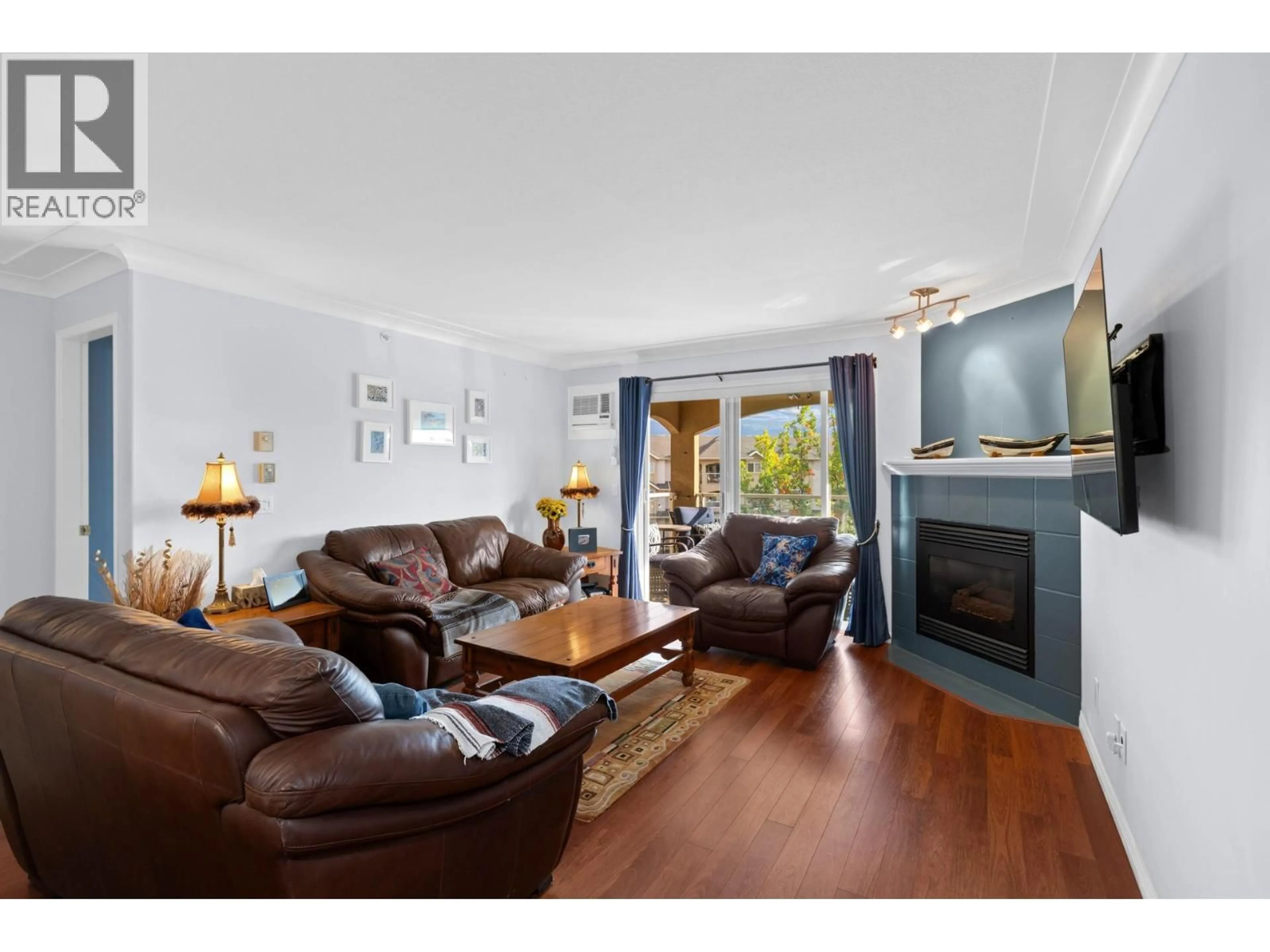 Living room with furniture, wood/laminate floor for 403 - 1964 ENTERPRISE WAY, Kelowna British Columbia V1Y9S5