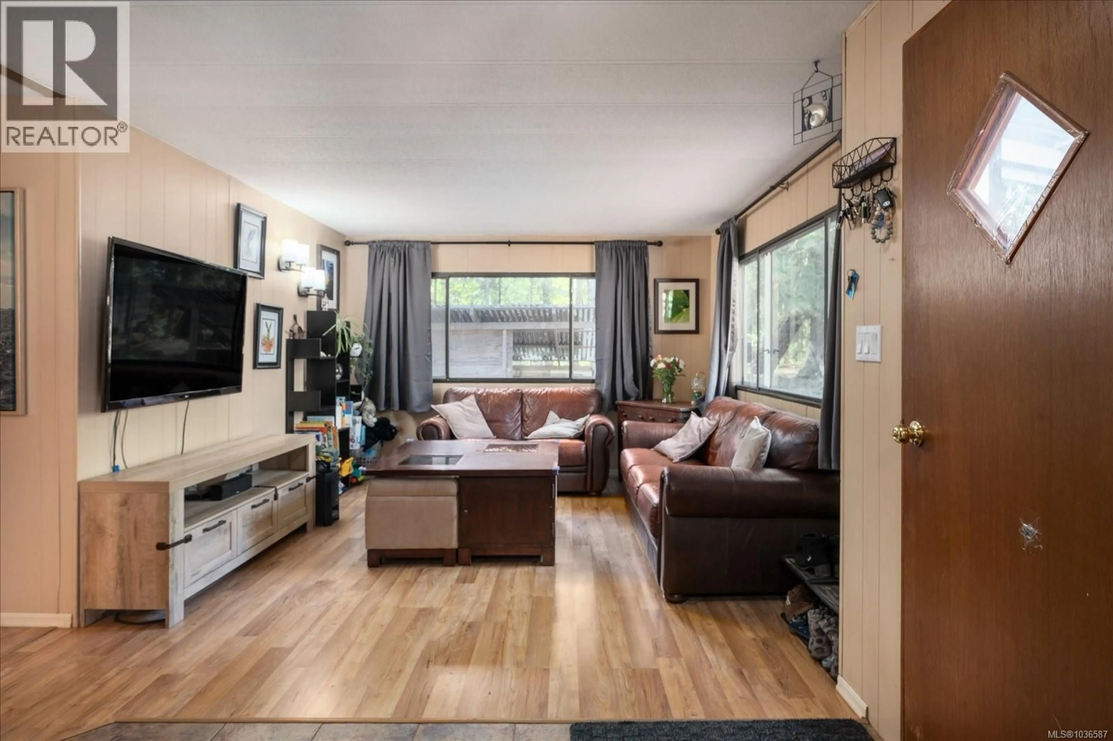 Living room with furniture, wood/laminate floor for 970 CARMEN CRESCENT, Gabriola Island British Columbia V0R1X2