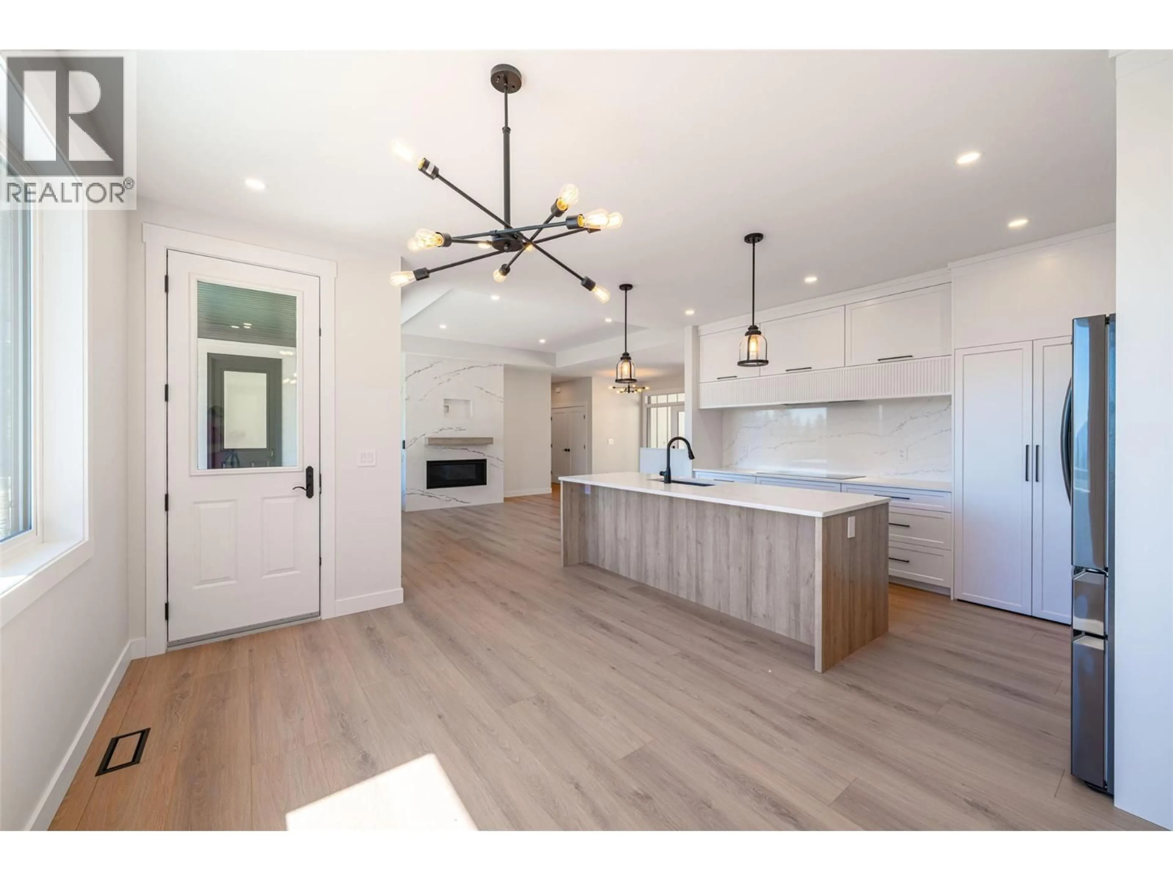 Open concept kitchen, wood/laminate floor for 7863 BOULTER ROAD, Vernon British Columbia V1B3N2